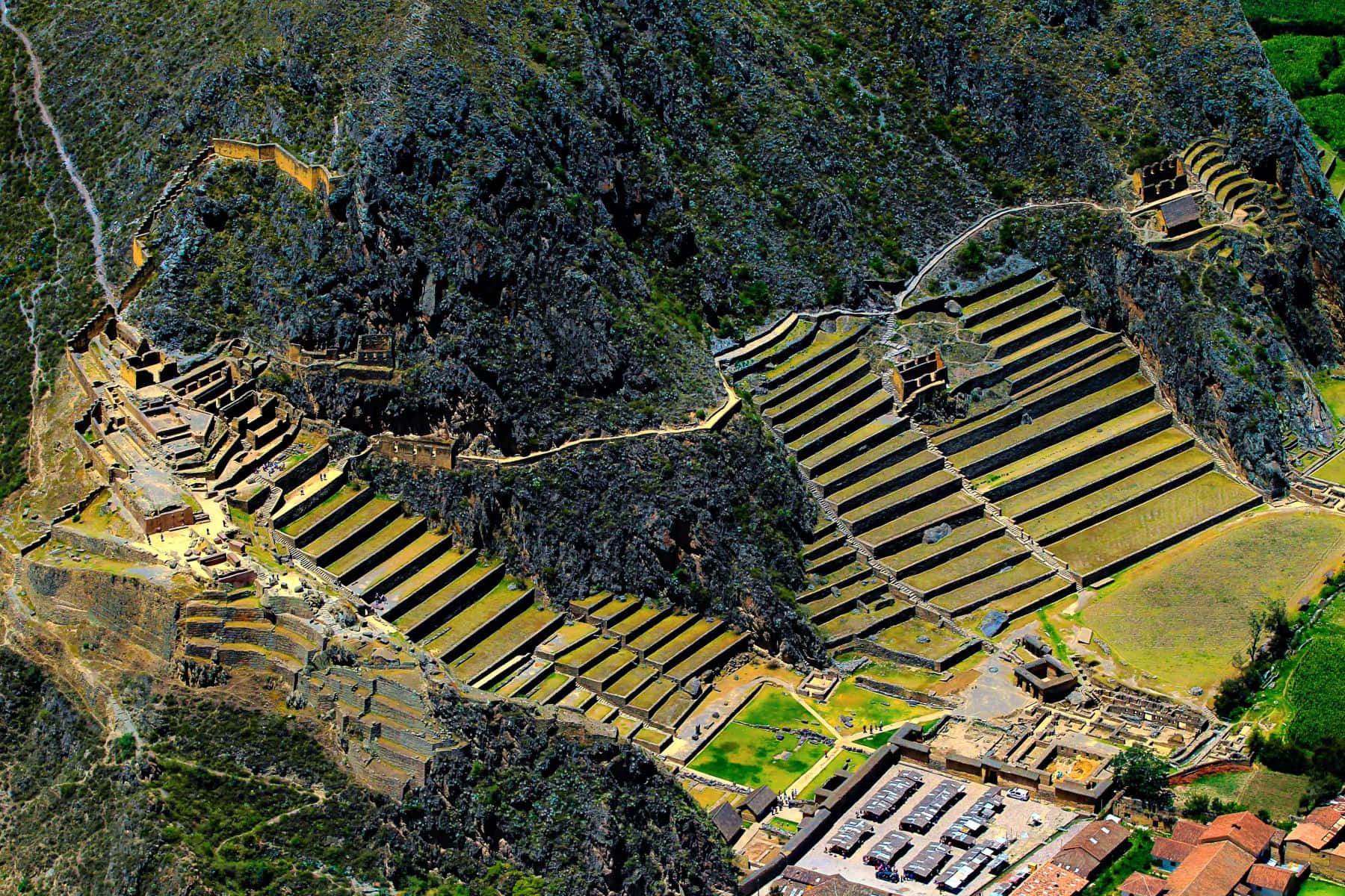 Caption: Majestic View Of Ollantaytambo Temple Hill Background