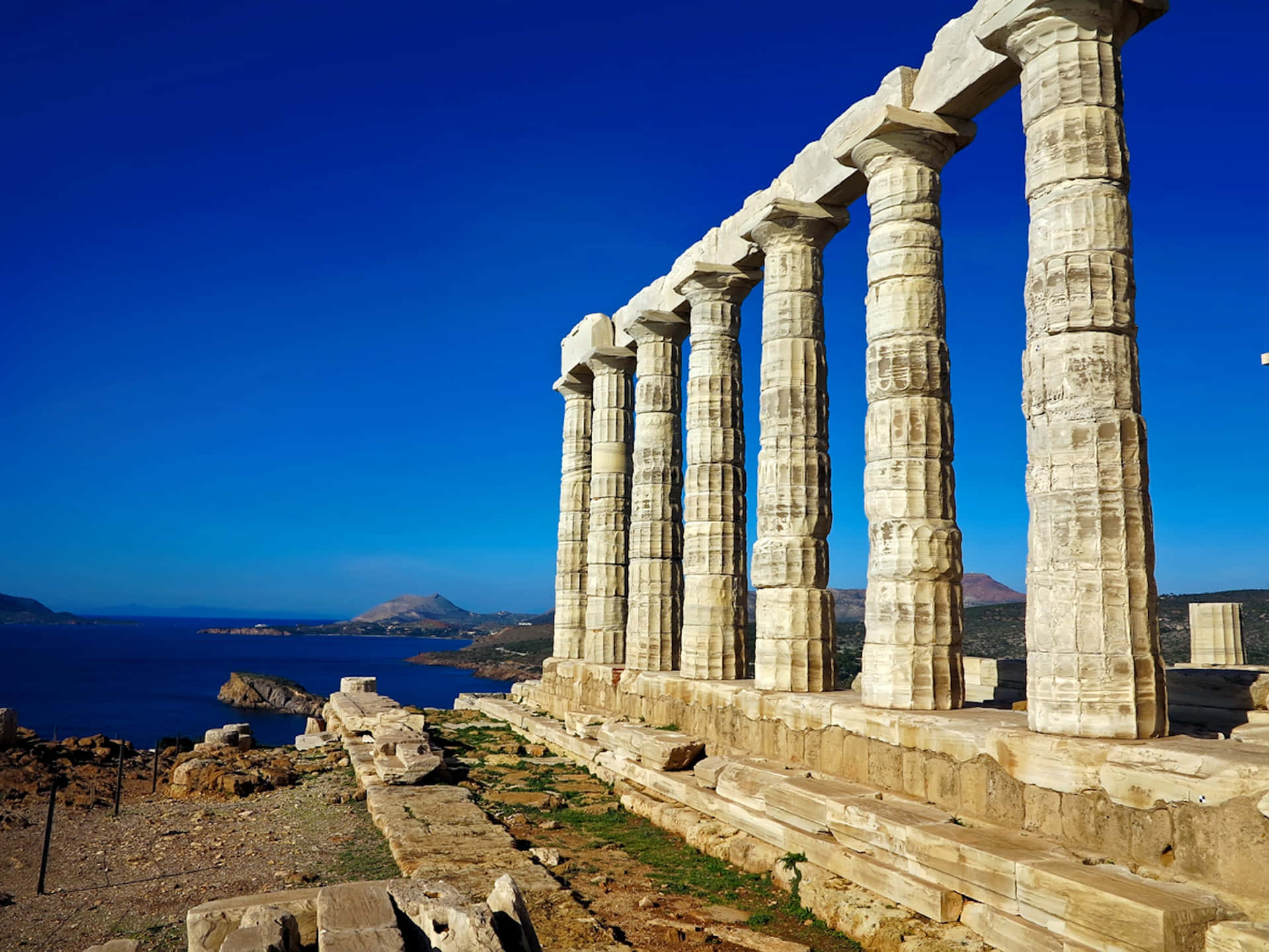 Caption: Majestic View Of The Temple Of Poseidon At Cape Sounion.