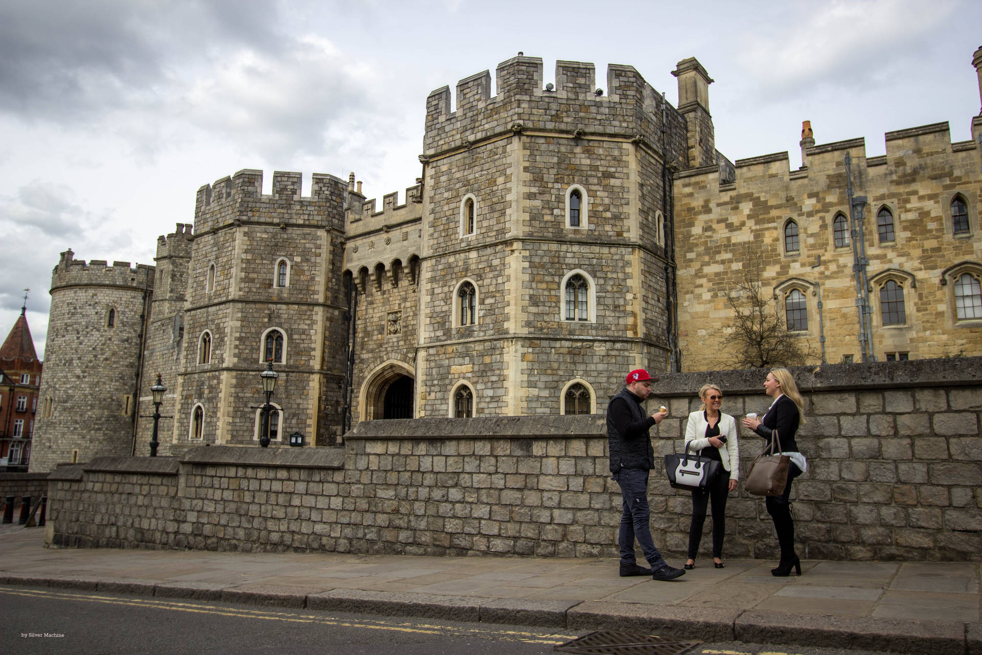 Caption: Majestic Windsor Castle Hosting Tourists Under An Overcast Sky. Background