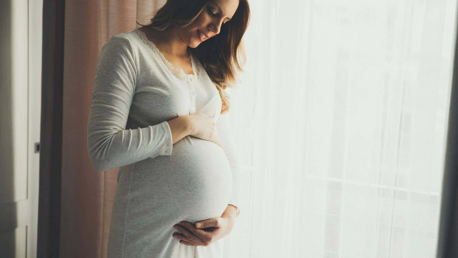 Caption: Maternal Bliss: A Glorious Pregnancy Portrait Background