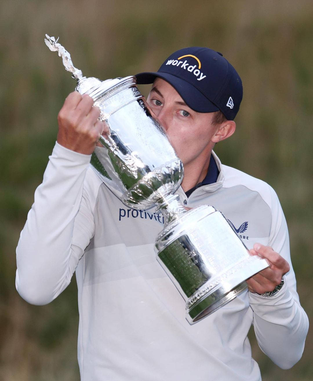 Caption: Matt Fitzpatrick Triumphantly Kissing Trophy Background