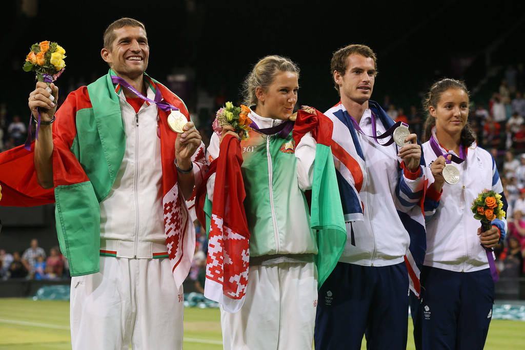 Caption: Max Mirnyi Celebrating Victory With Fellow Winners Background