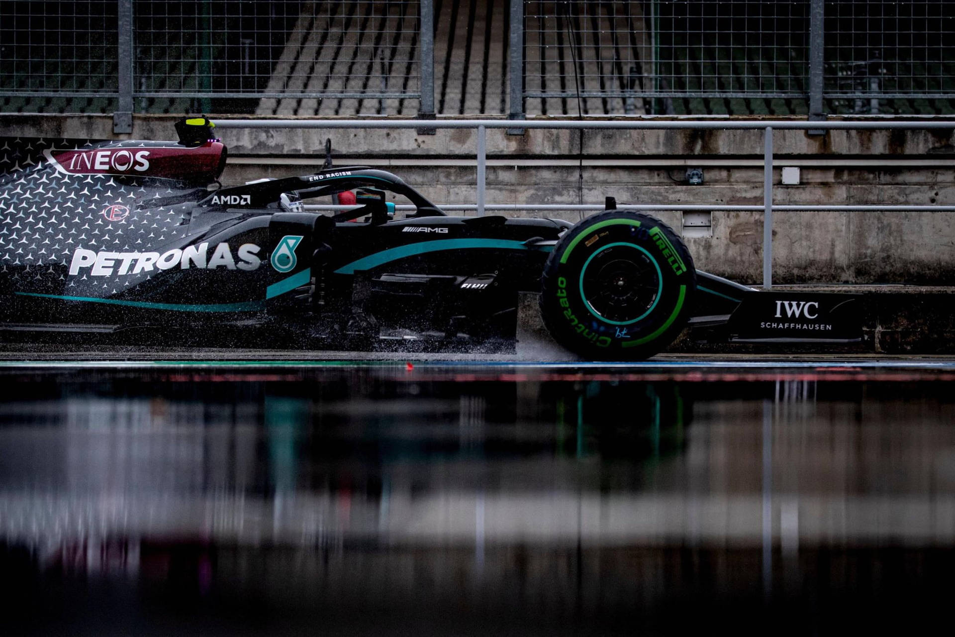 Caption: Mercedes Amg Petronas F1 Racing Car On Track Background