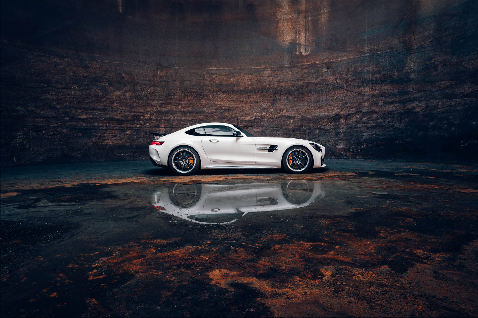 Caption: Mesmerizing Reflection Of Amg Gtr In A Puddle