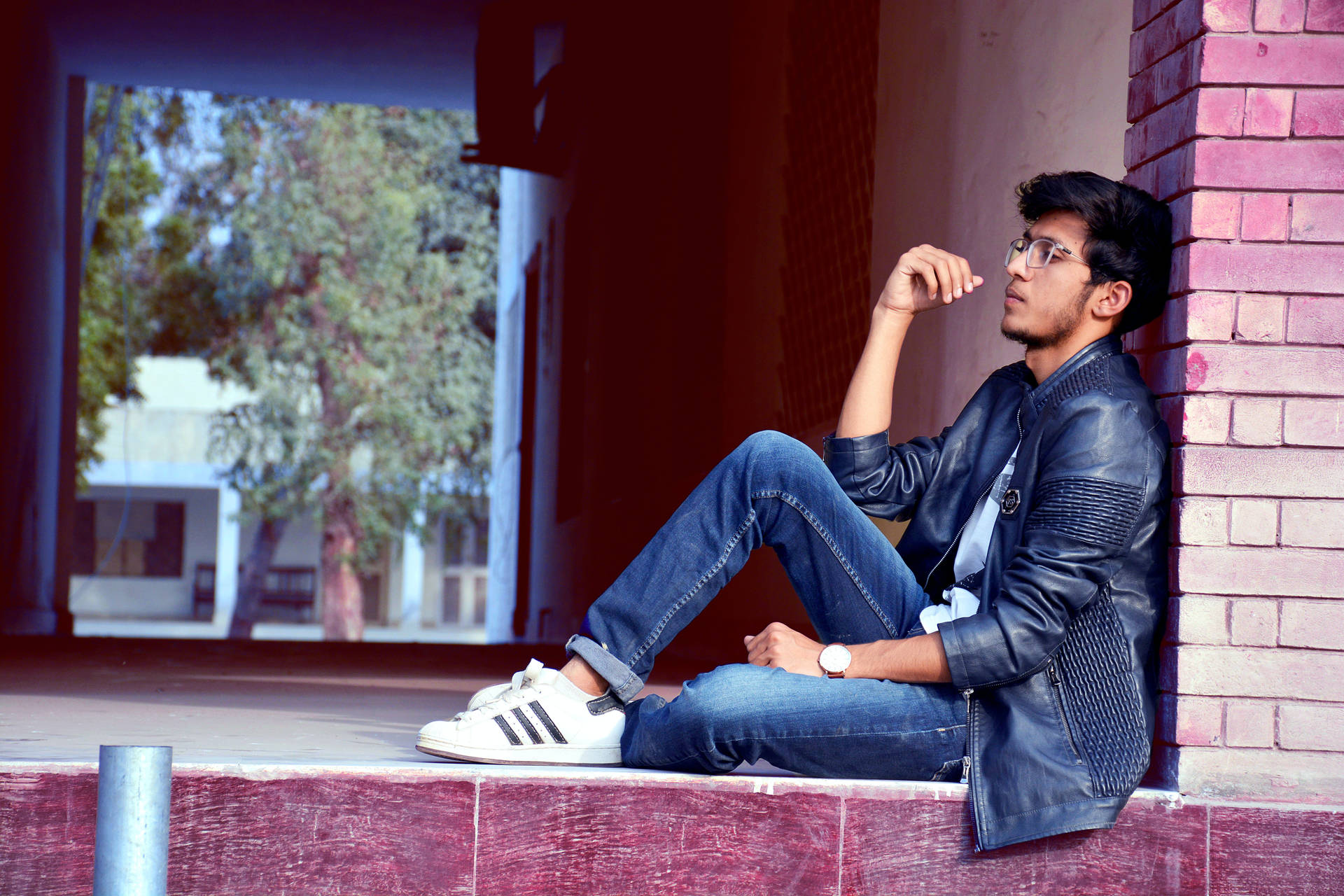 Caption: Modern Elegance: Dynamic Male Model Displaying Casual Denim Fashion Background