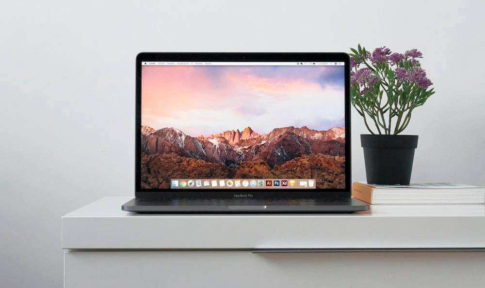 Caption: Modern Macbook Laptop With A Floral Accent Background