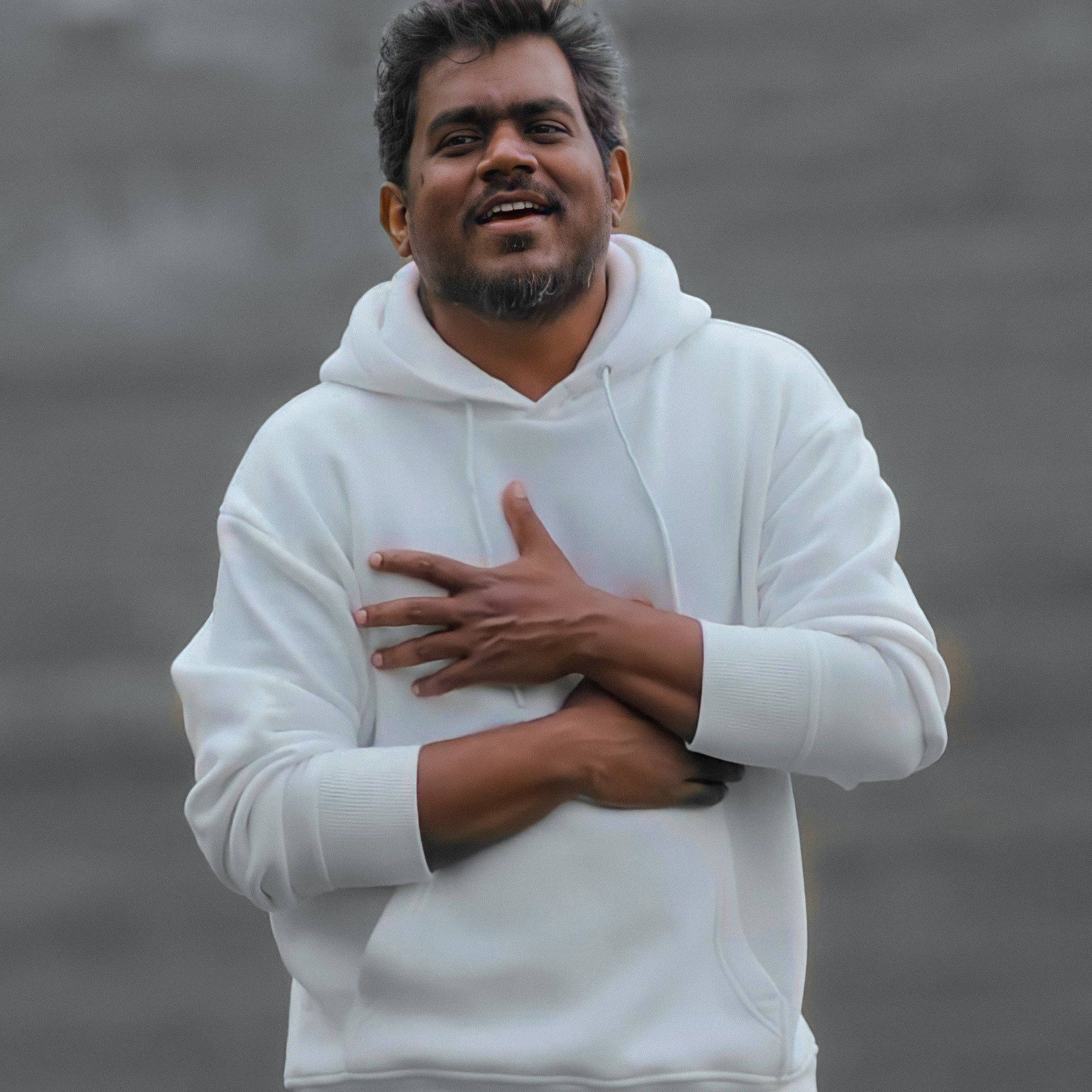 Caption: Music Maestro Yuvan Shankar Raja In A Stylish White Hoodie Background