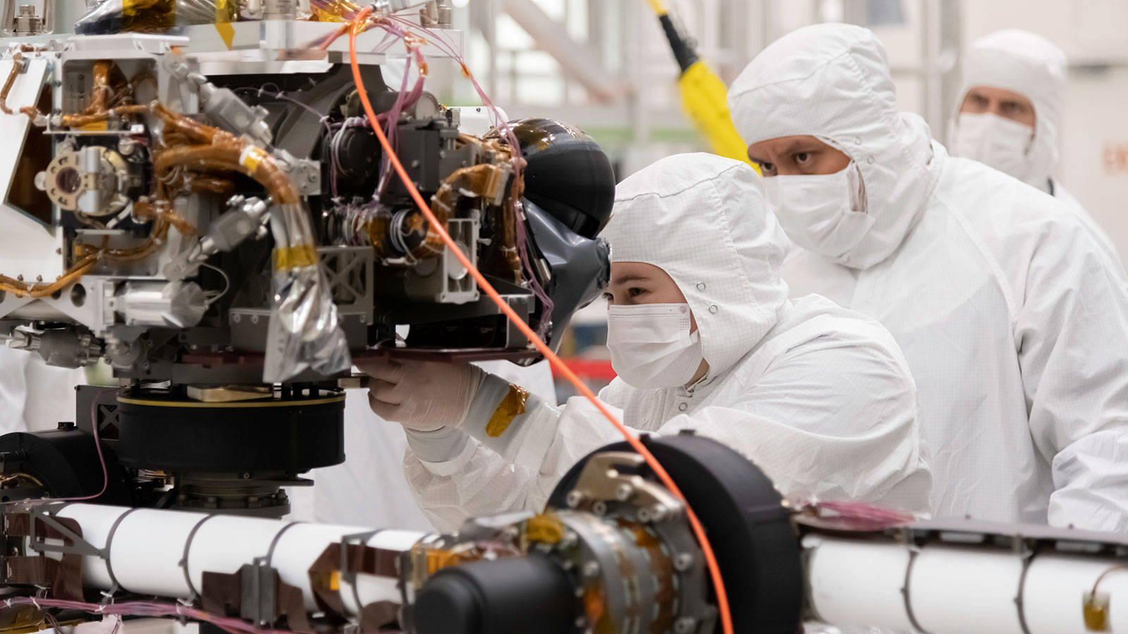 Caption: Nasa Engineering Technician Working On Mars 2020 Perseverance Rover