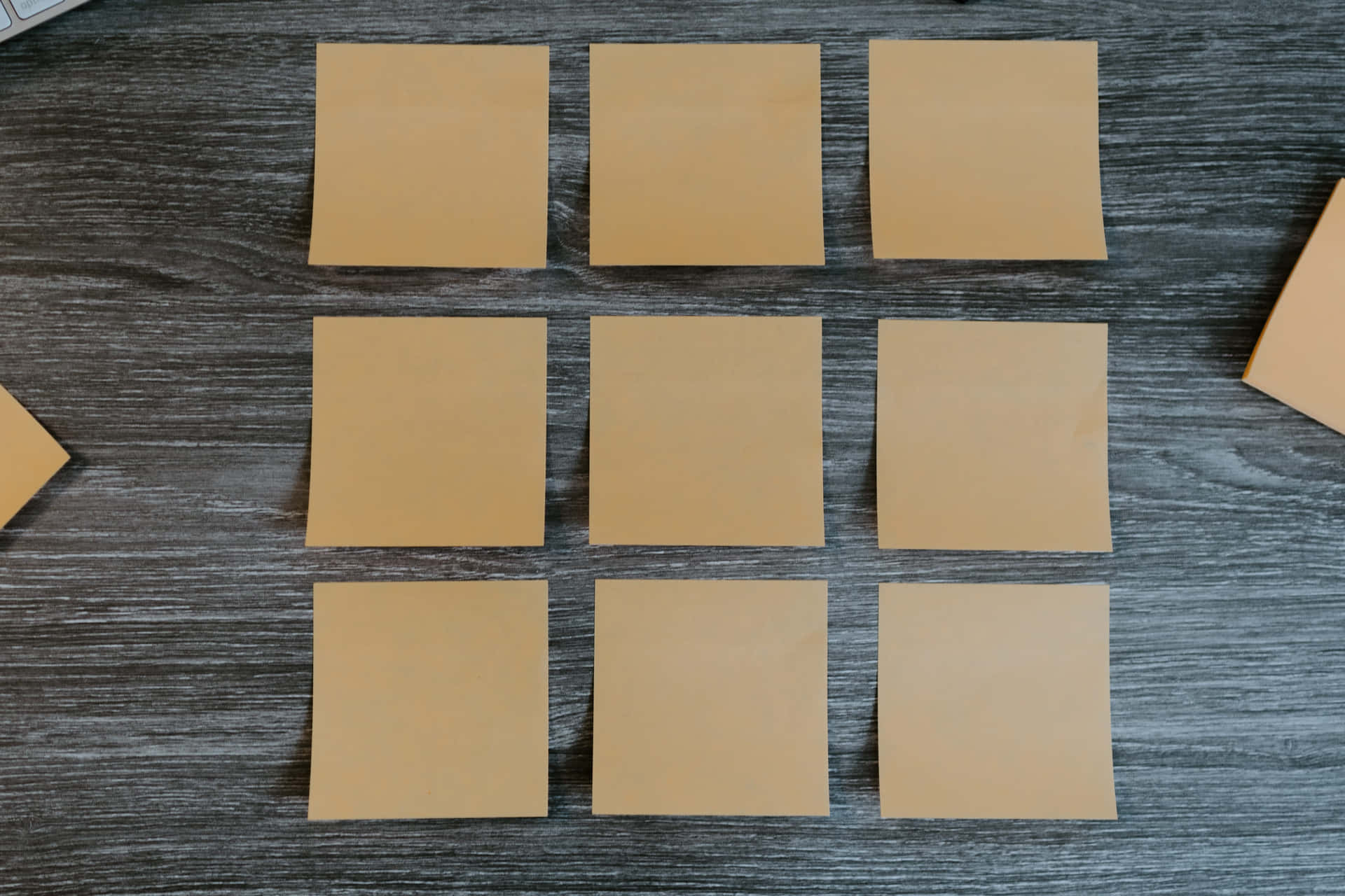 Caption: Neatly Arranged Sticky Notes On A Board