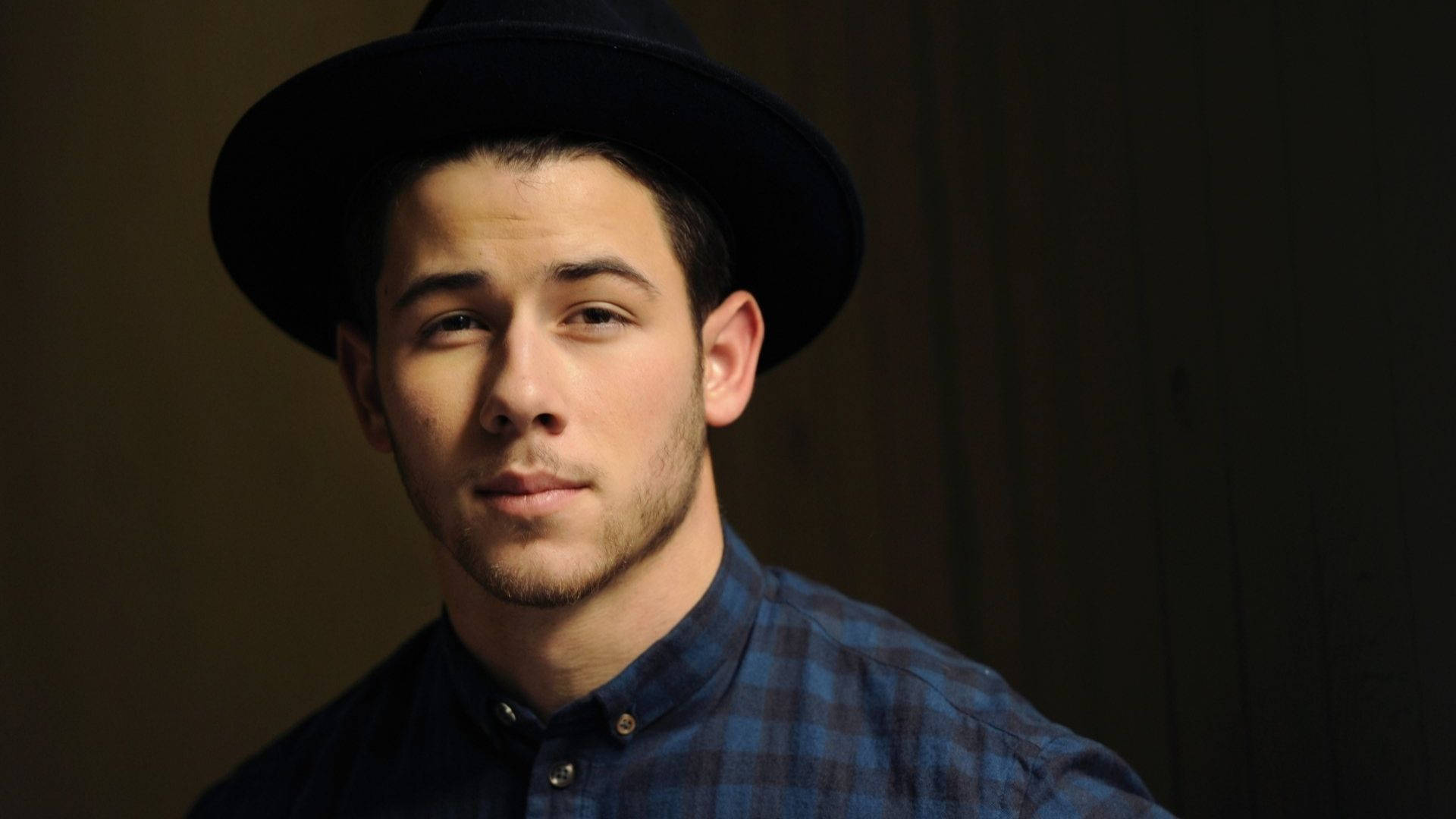 Caption: Nick Jonas Exudes Coolness In A Checkered Polo.