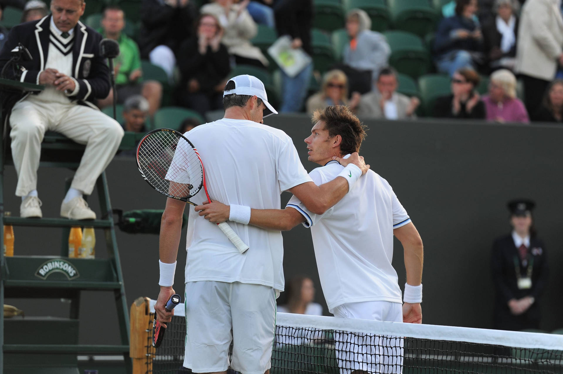 Caption: Nicolas Mahut And John Isner Strategizing On Court