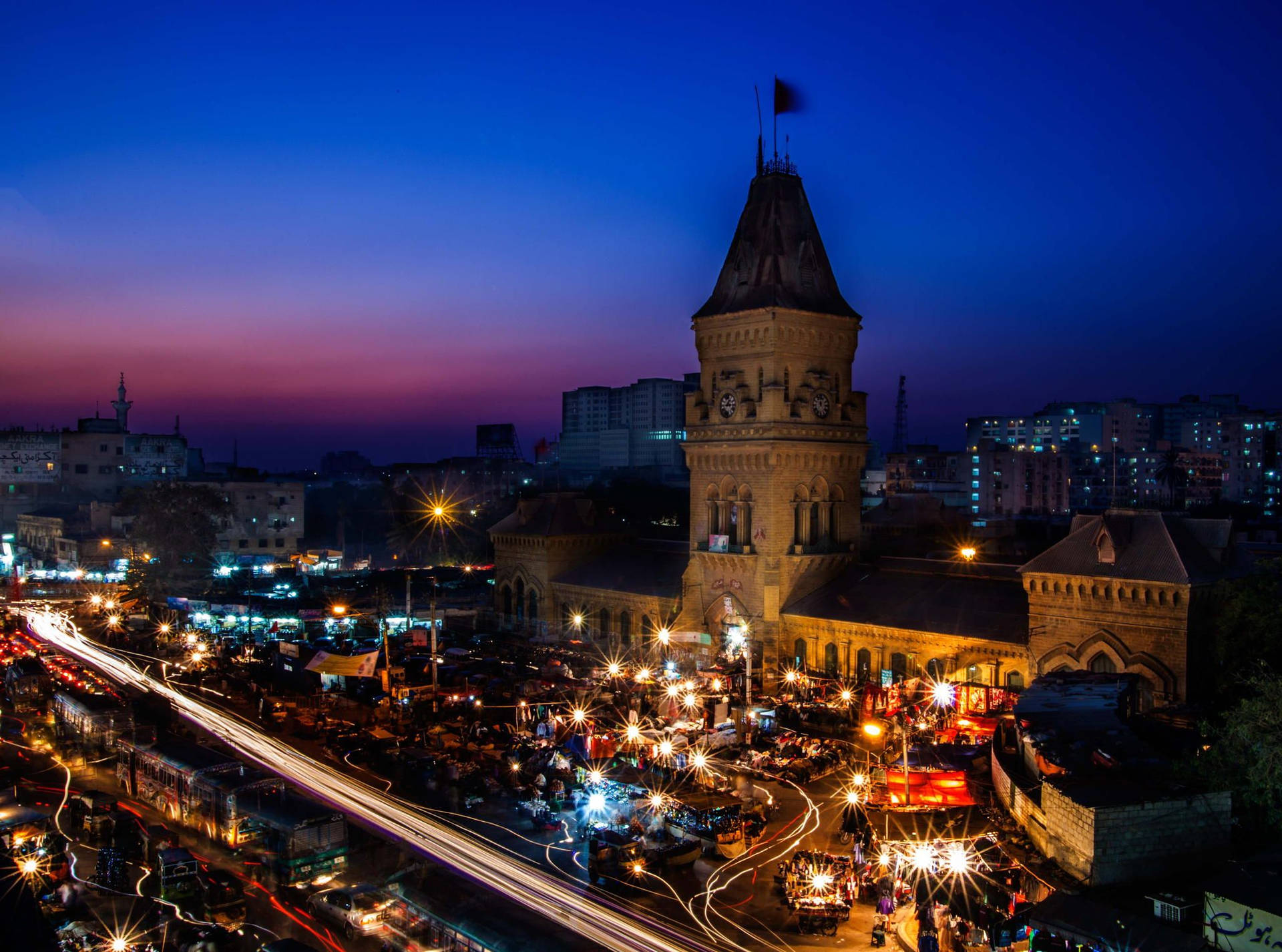 Caption: Night View Of The Iconic Empress Market In Karachi Background