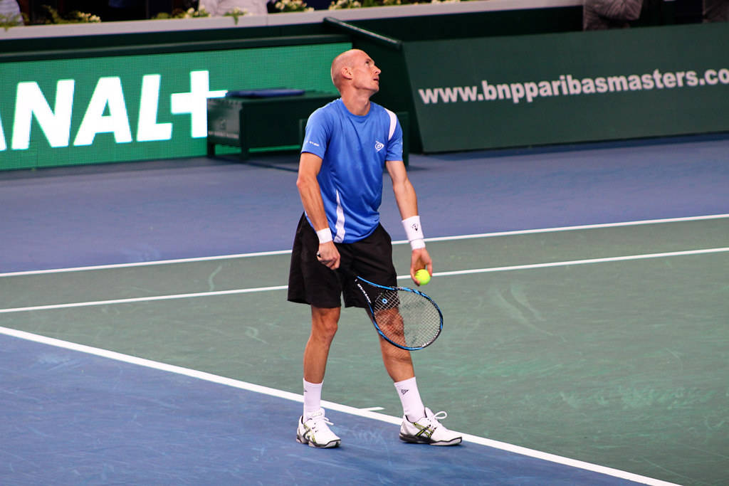 Caption: Nikolay Davydenko Serving At The Indian Wells Open Background