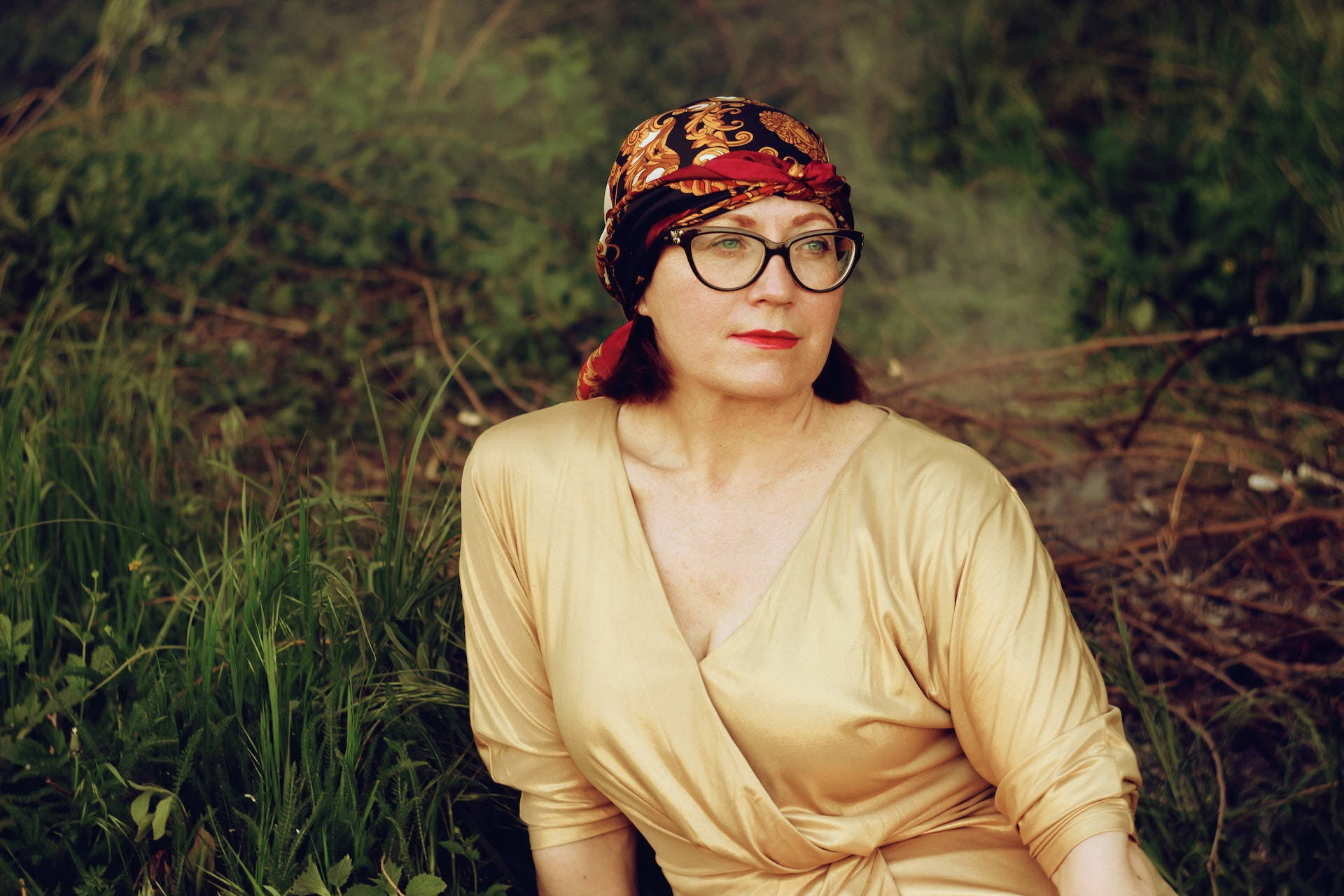 Caption: Older Woman In A Bandanna Radiating Wisdom And Vitality Background