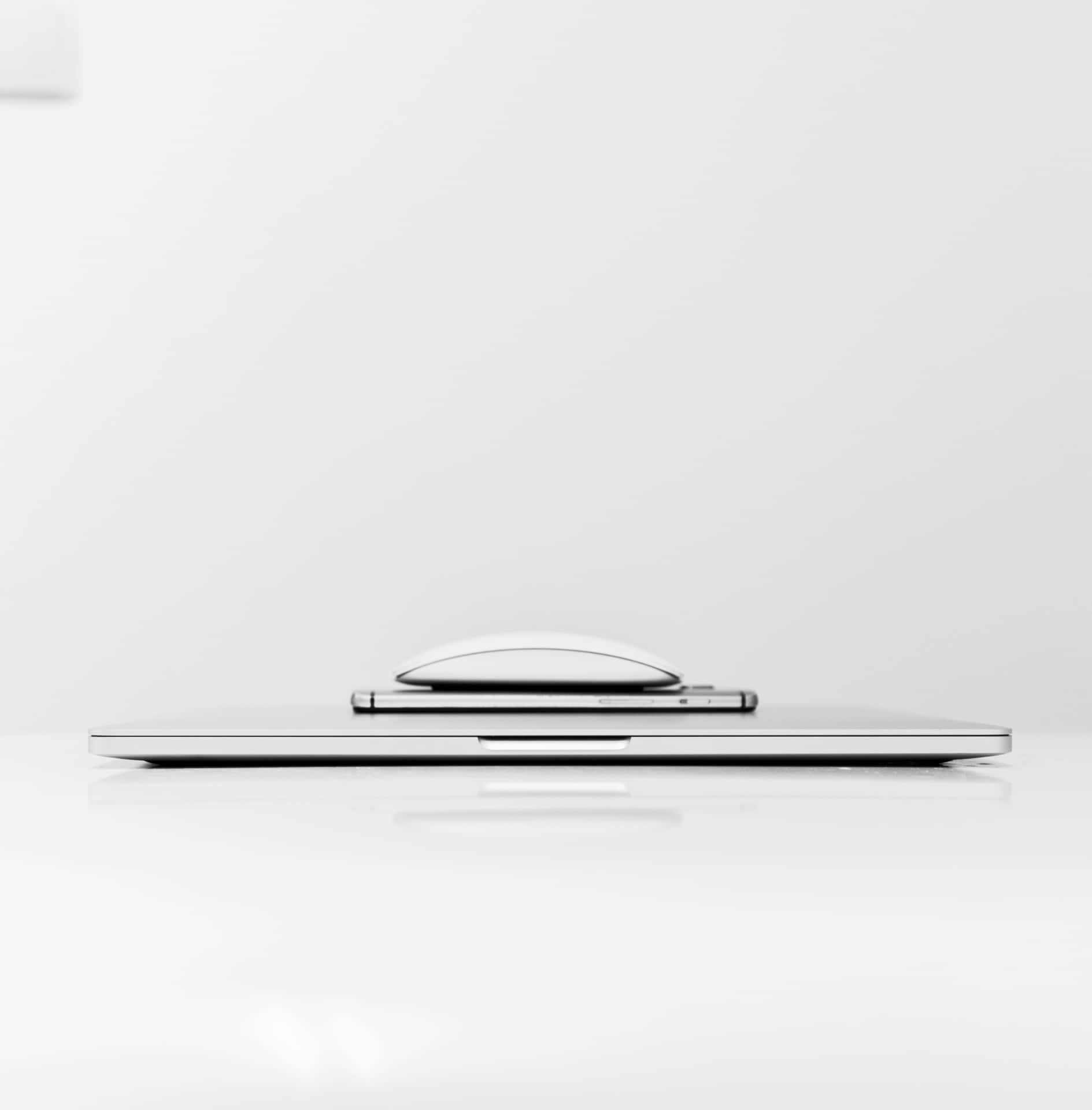 Caption: Organized Gadgets On Desk Background