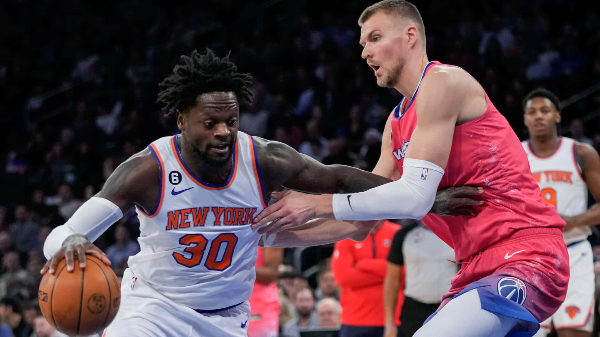 Caption: Patrick Ewing In Action On The Basketball Court Background