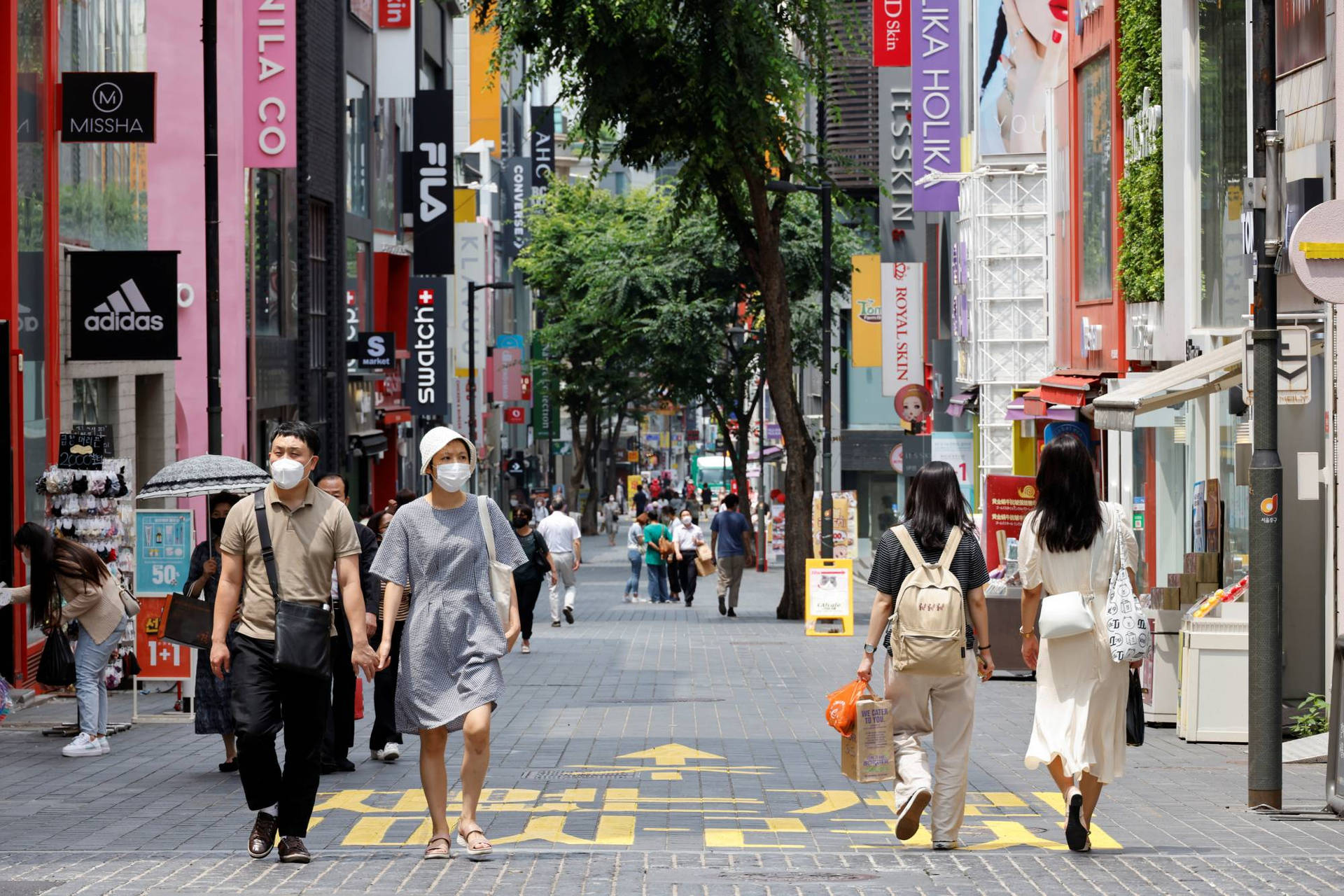 Caption: People In Medical Masks In A Crowd Background