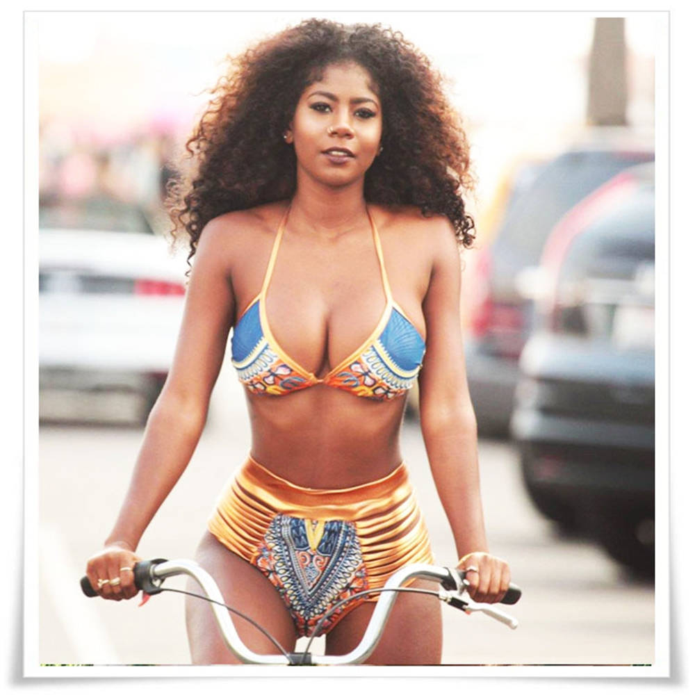 Caption: Picturing Elegance: A Graceful Black Woman Enjoys The Beach Background