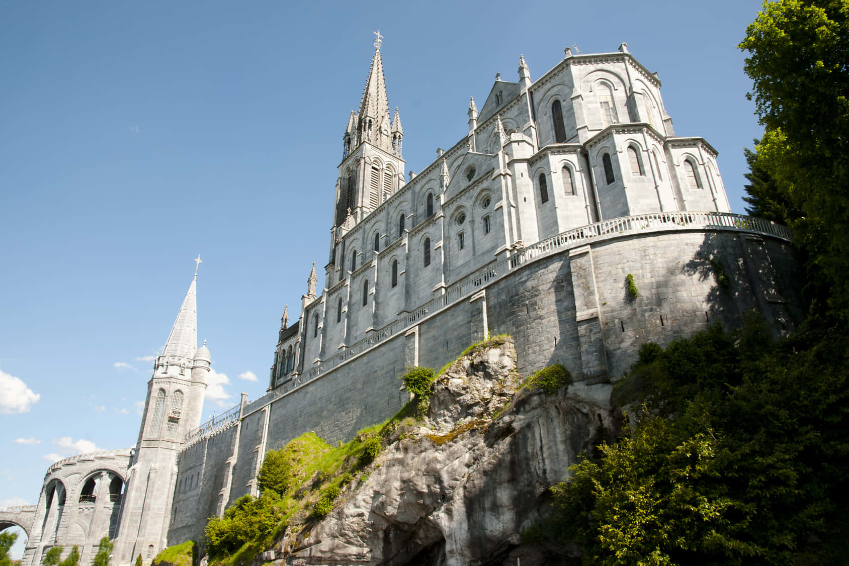 Caption: Pilgrims At The Spiritual Lourdes Sanctuary Background