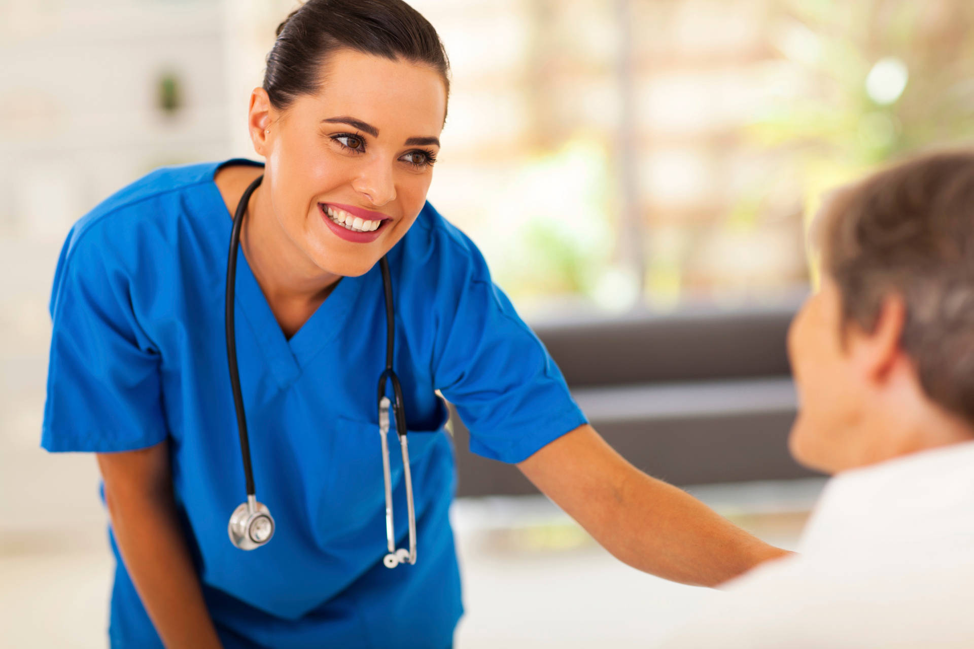 Caption: Polite Nurse Administering Treatment To A Patient Background