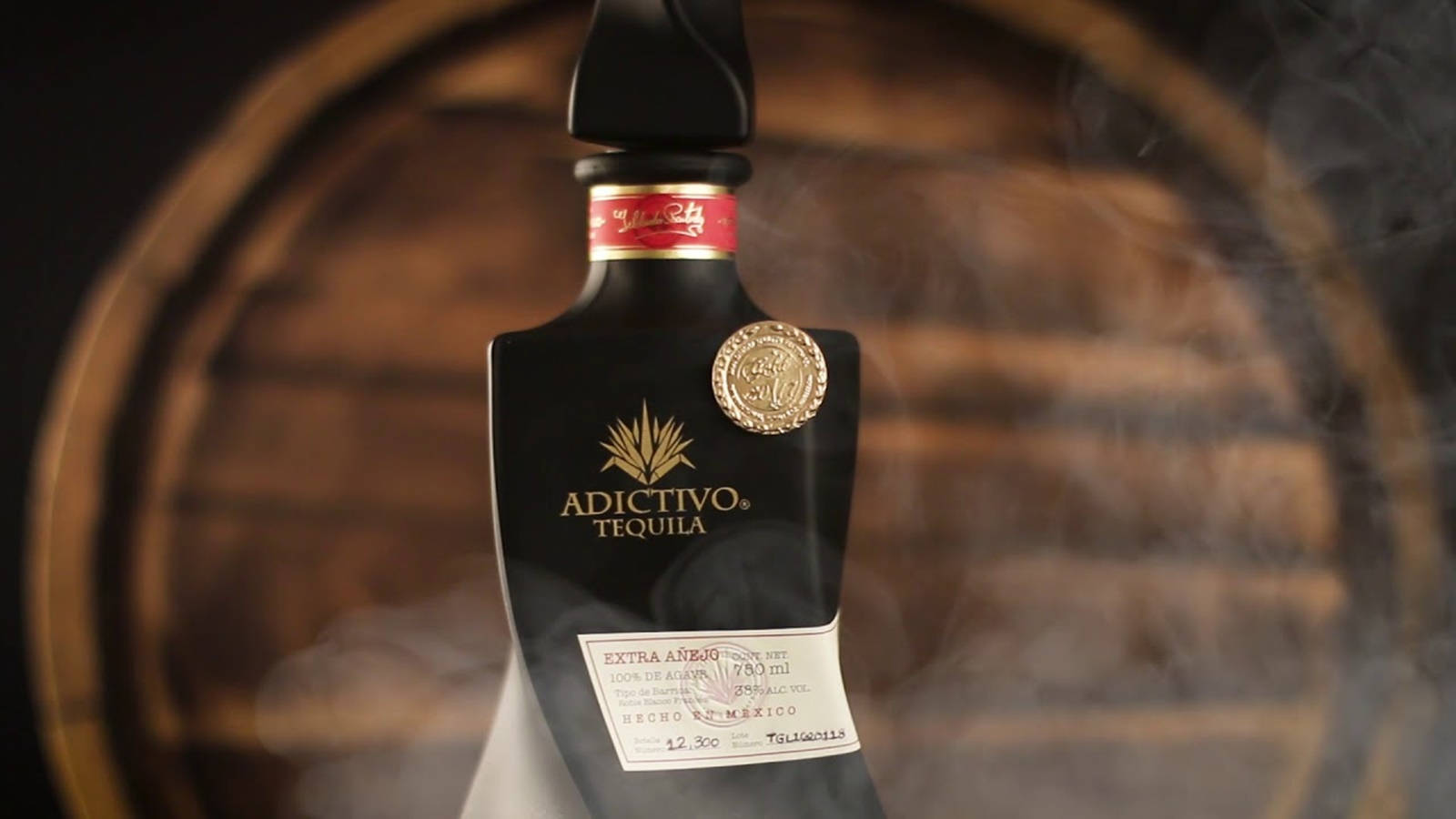 Caption: Premium Adictivo Extra Anejo Black Tequila - A Luxury Statement Background