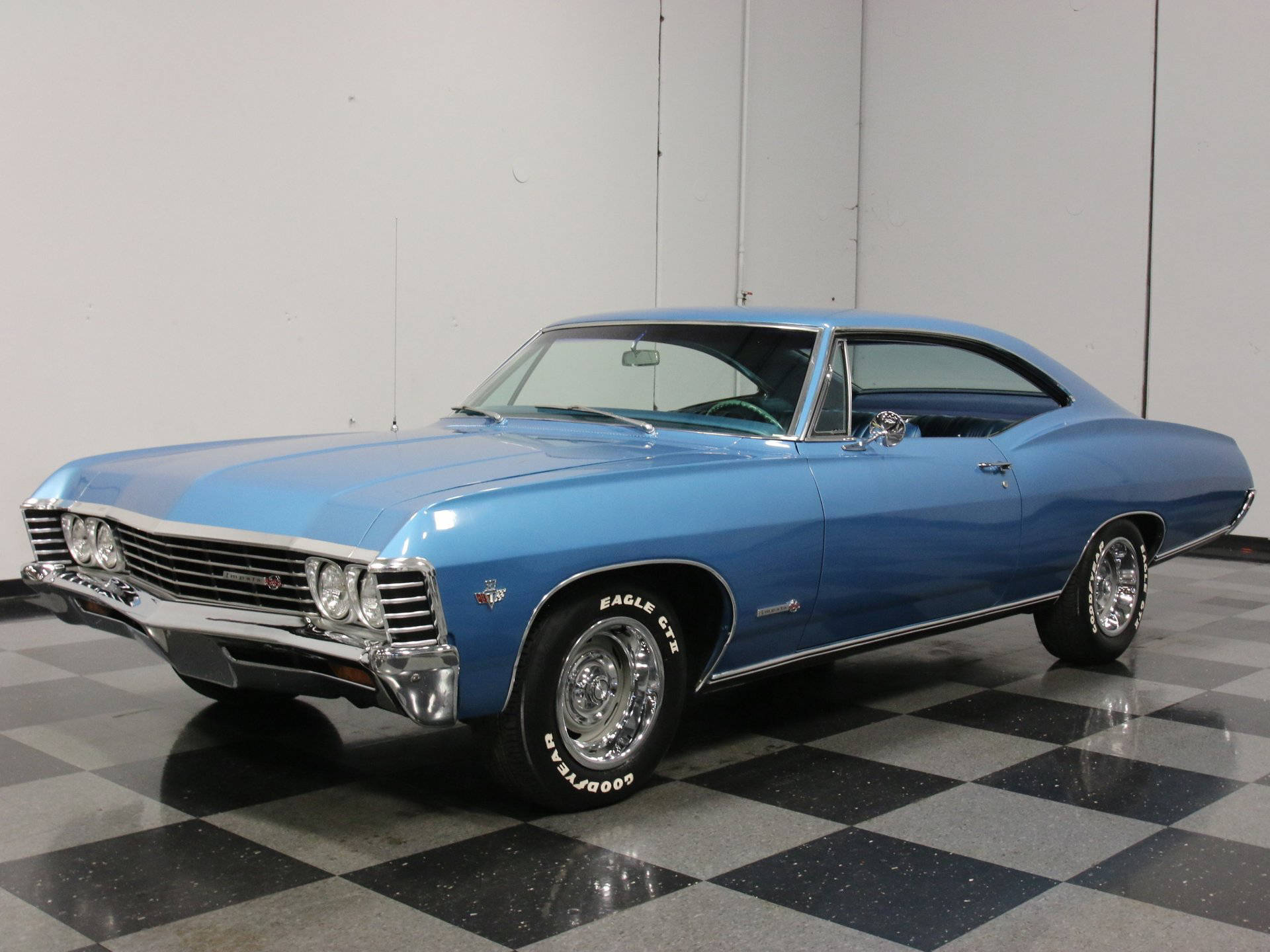 Caption: Pristine 1967 Chevrolet Impala In Marina Blue Background