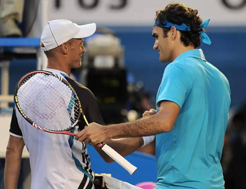 Caption: Pro Tennis Players Nikolay Davydenko And Roger Federer Discussing During Match Background