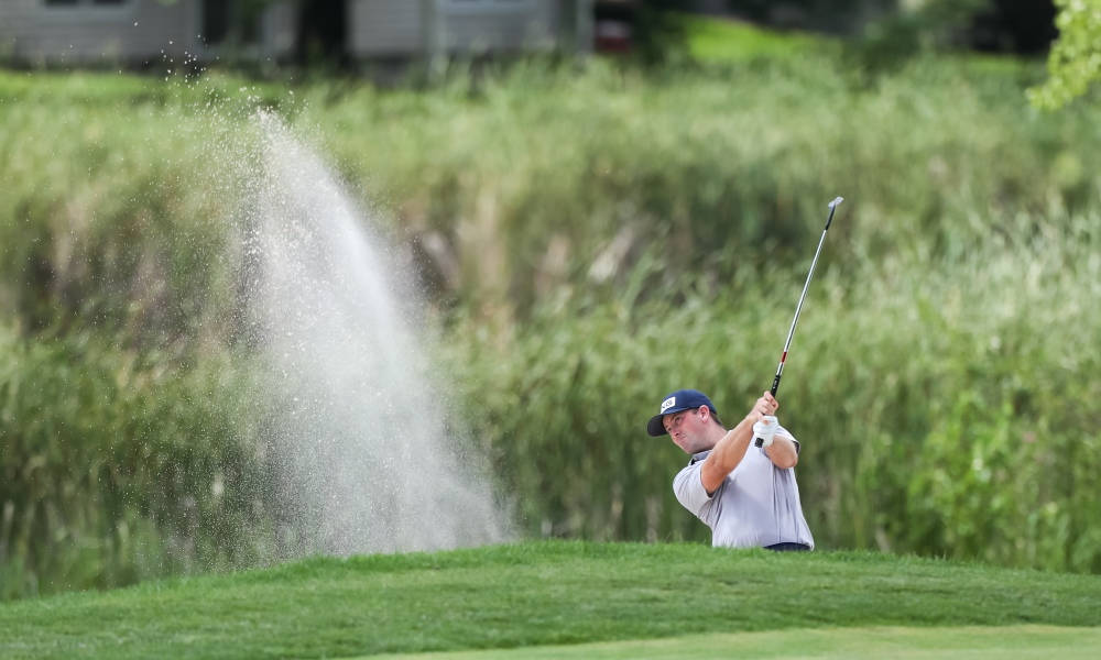 Caption: Professional Golf Player - Michael Thompson In Swing Action Background