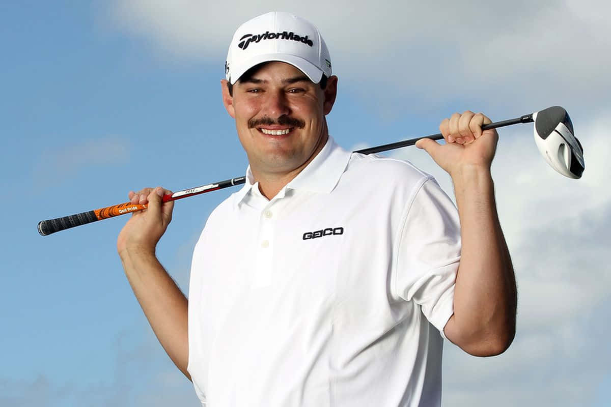Caption: Professional Golfer Johnson Wagner Posing With Club On Shoulder Background