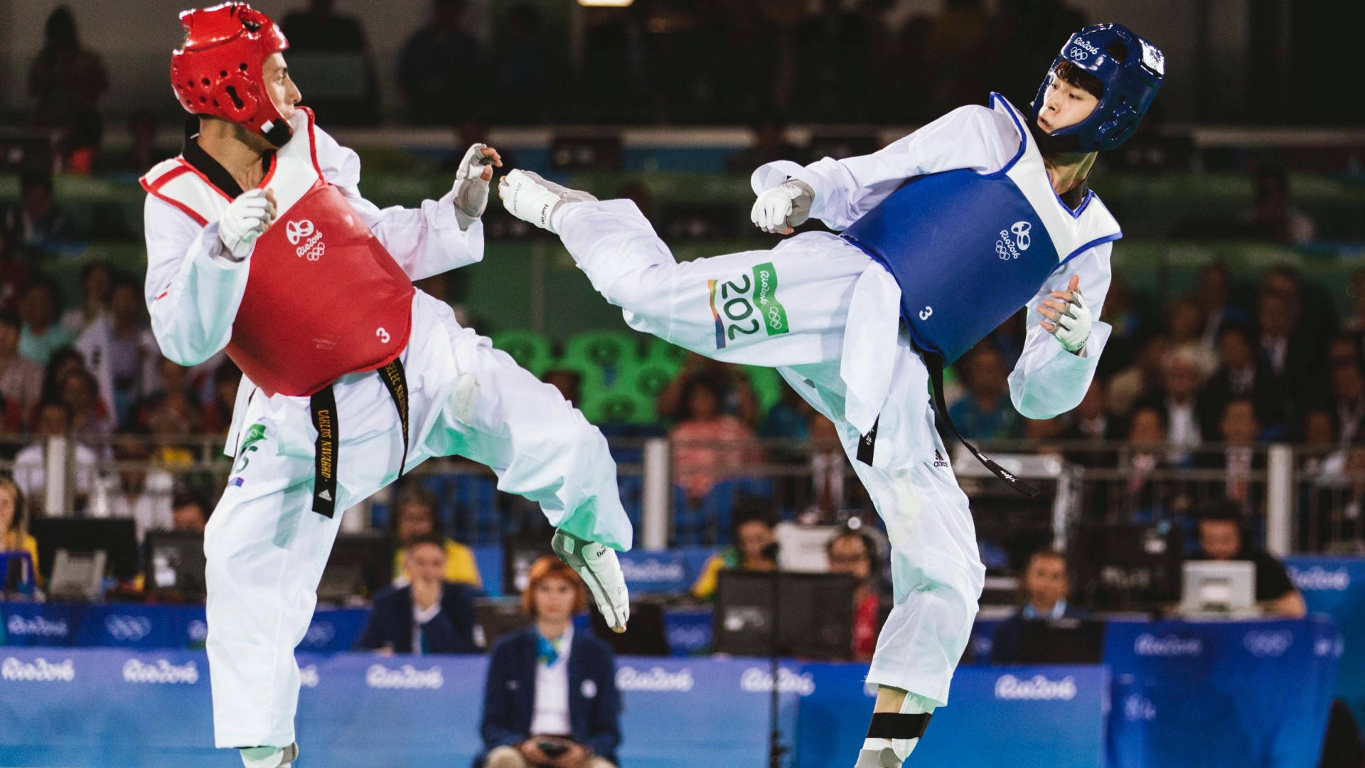 Caption: Professional Taekwondoka In Action At The Rio Summer Olympics 2016. Background