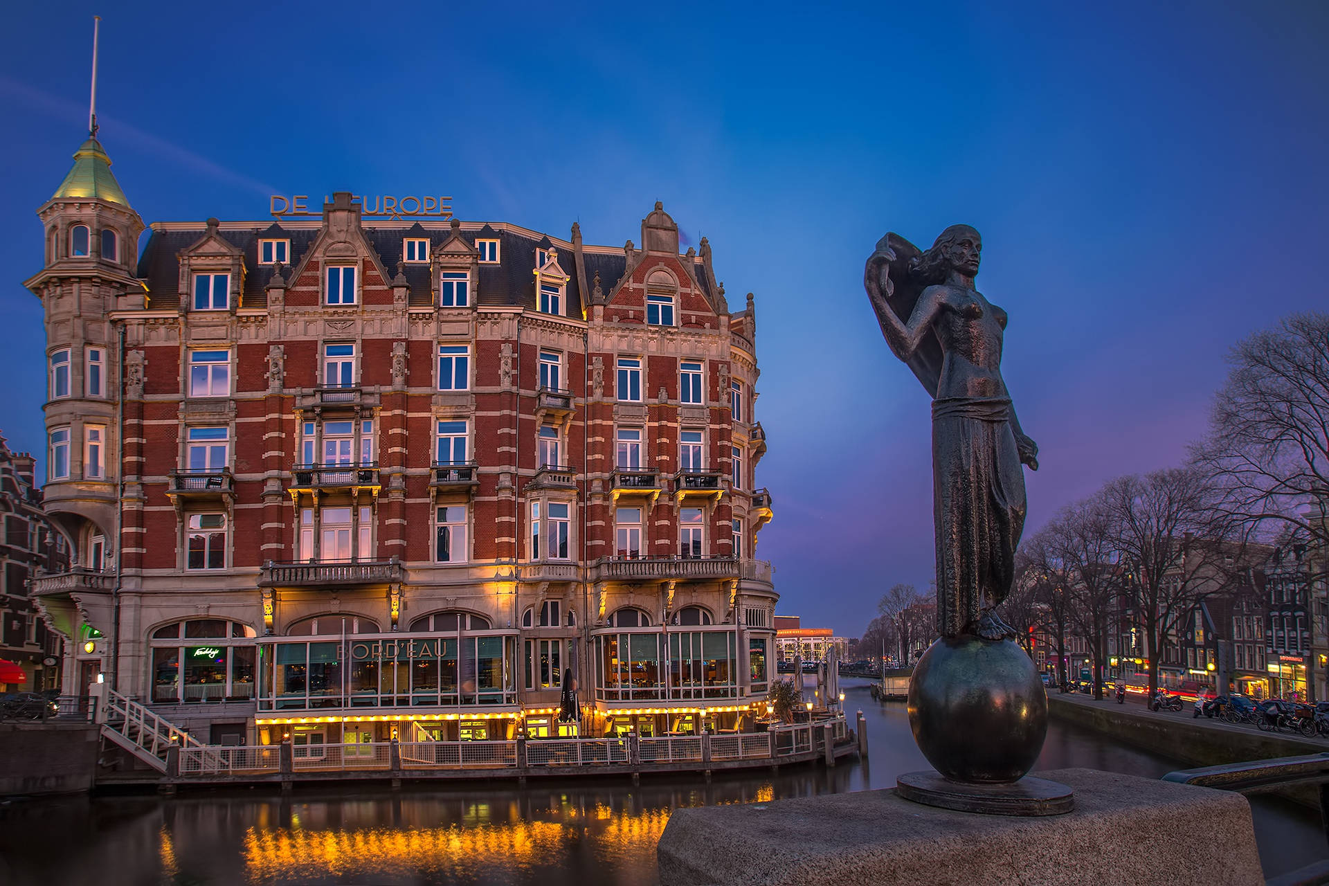 Caption: Quaint Restaurant Flore Amidst Dutch Cityscape Background