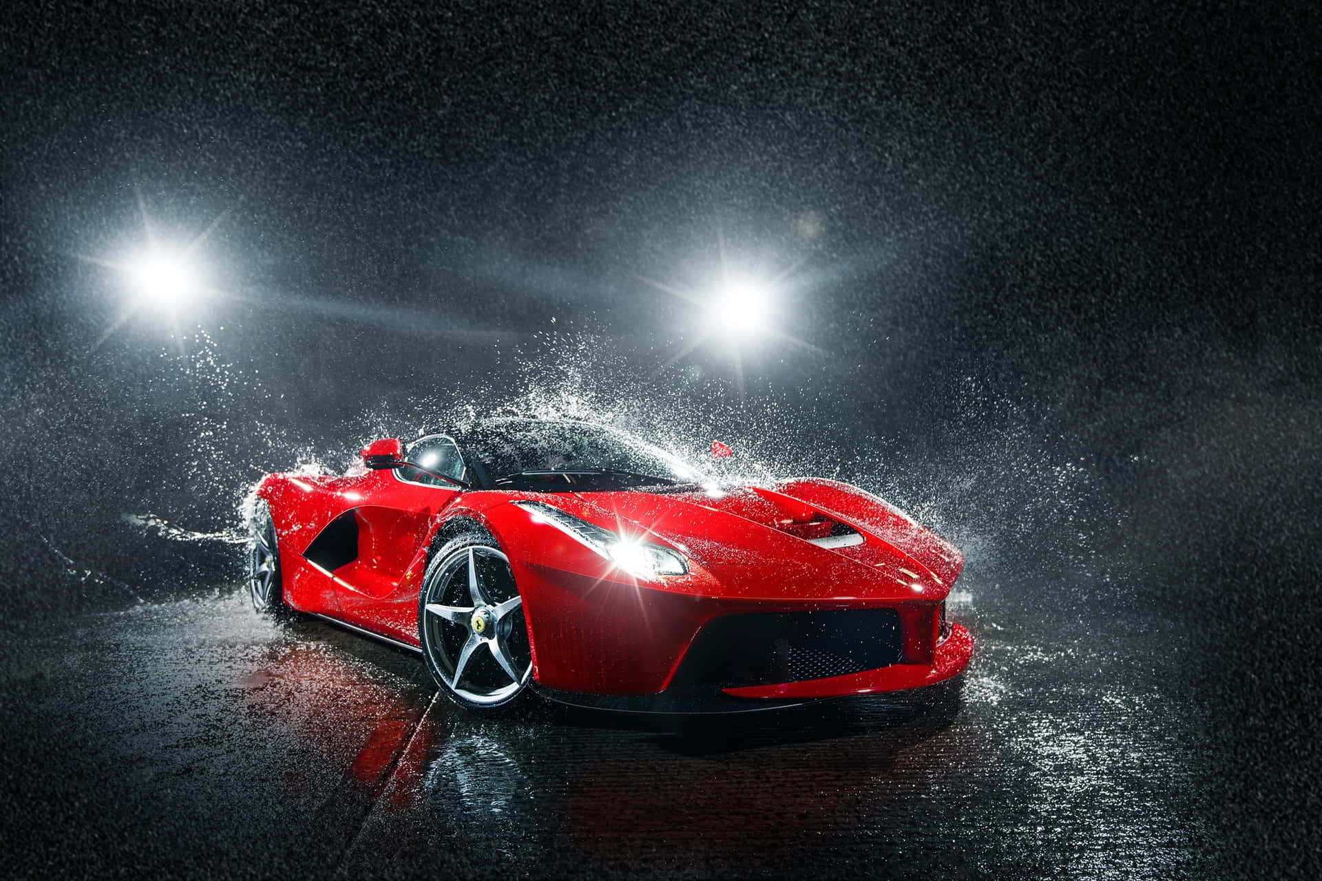 Caption: Red Car Experiencing Top-notch Detailing In Rain Background