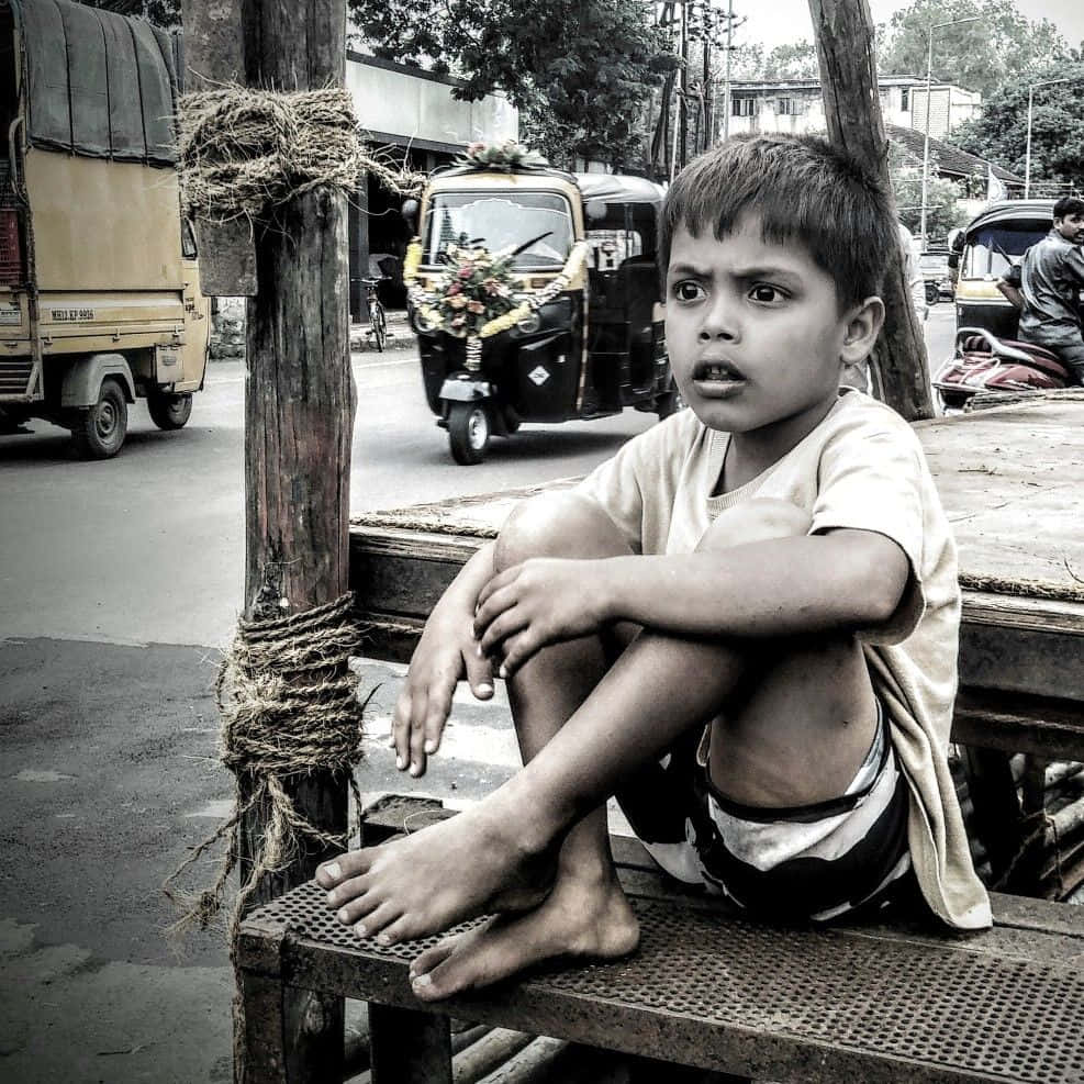 Caption: Reflective Moment In A Busy Street Background