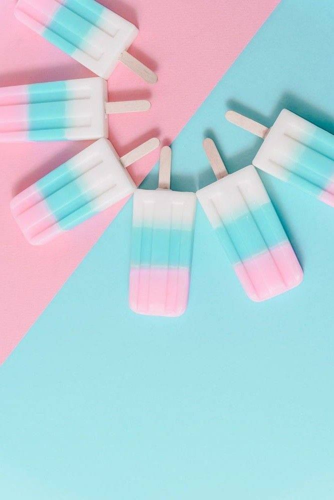 Caption: Refreshing Pink And Blue Popsicles Background