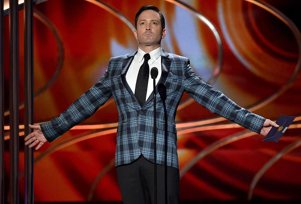 Caption: Renowned Actor Thomas Lennon In A Sophisticated Pose Background