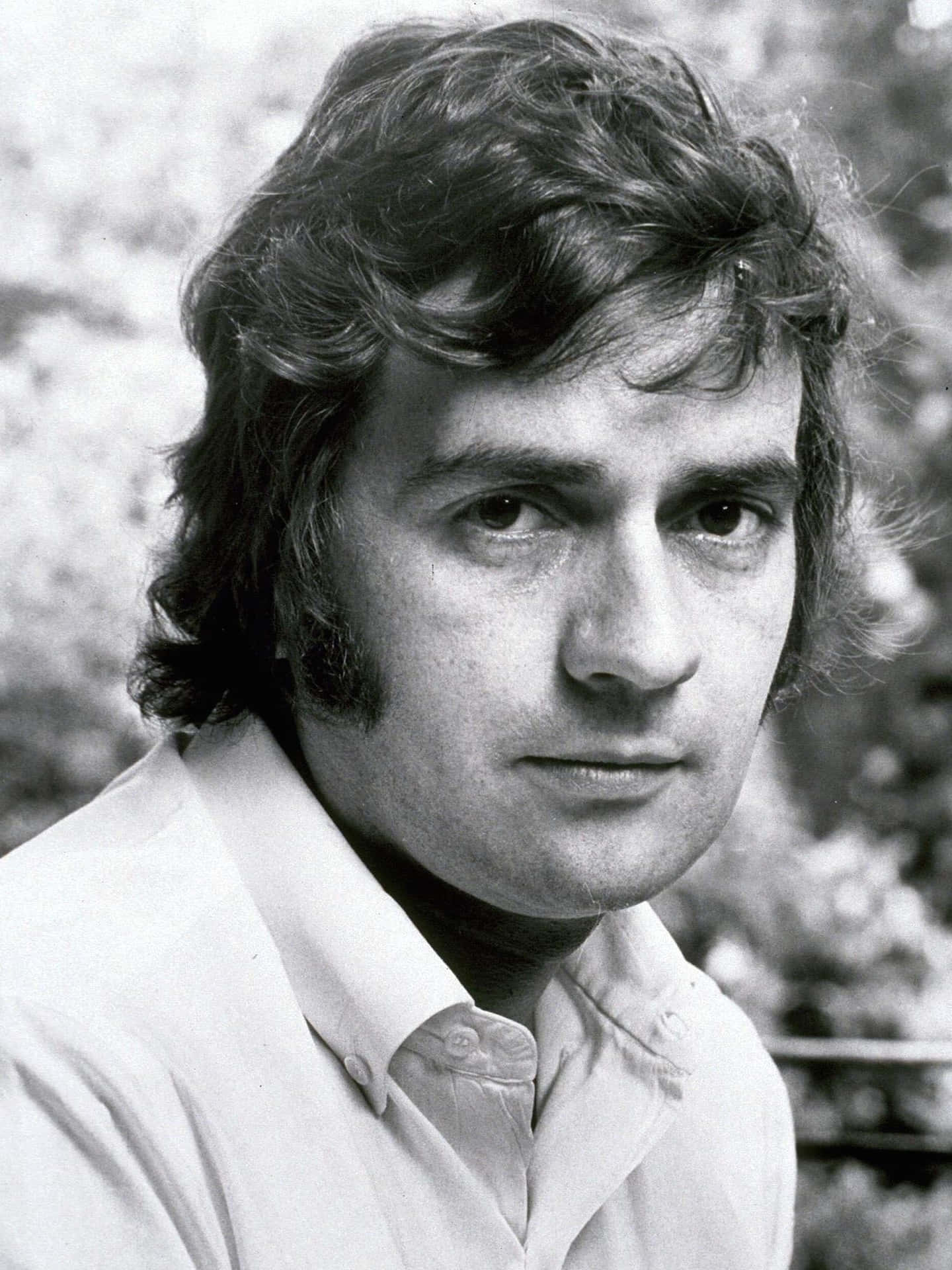 Caption: Renowned English Actor And Comedian Dudley Moore Posing For A Portrait Background