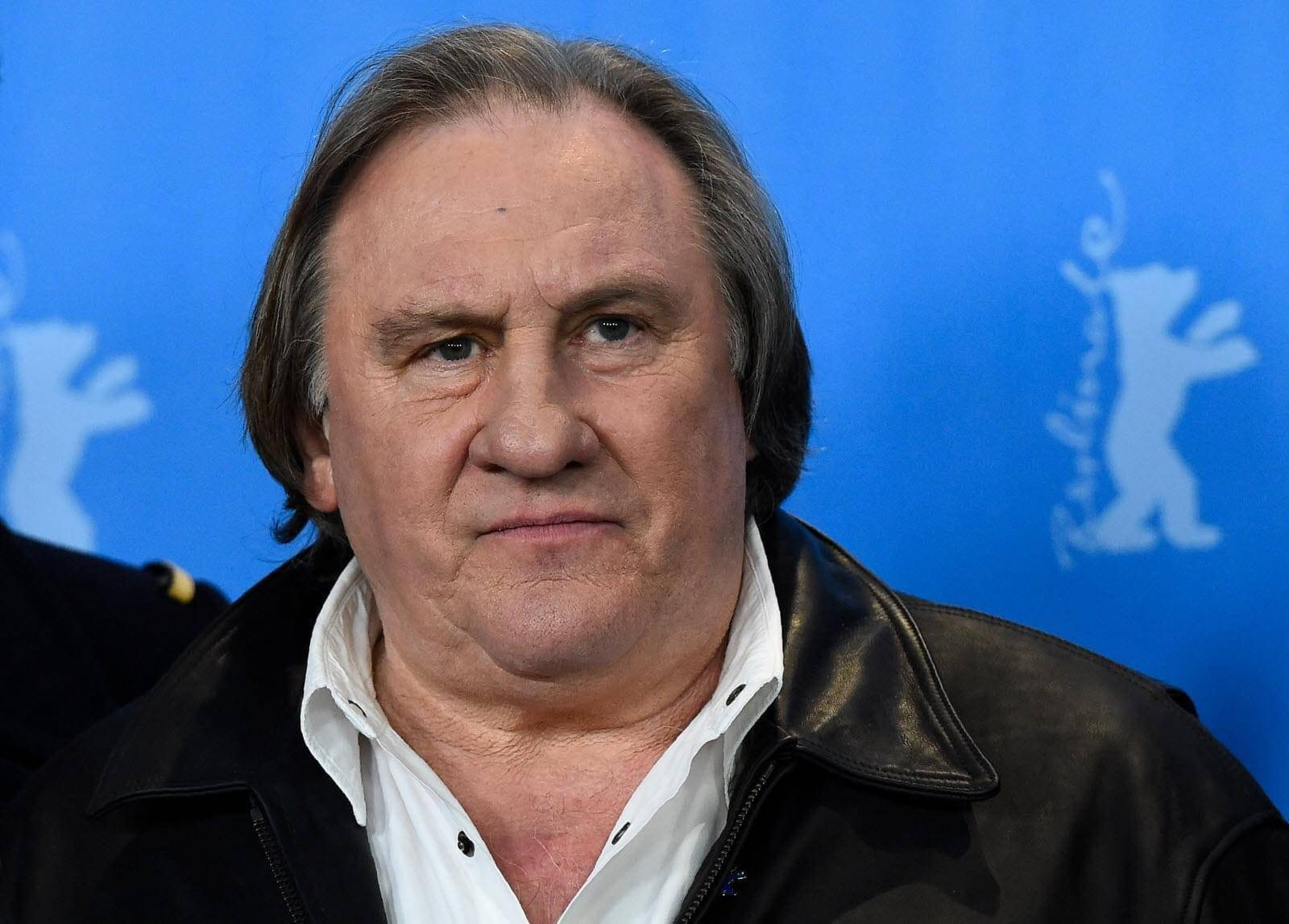 Caption: Renowned French Actor Gérard Depardieu Posing Against A Blue Background