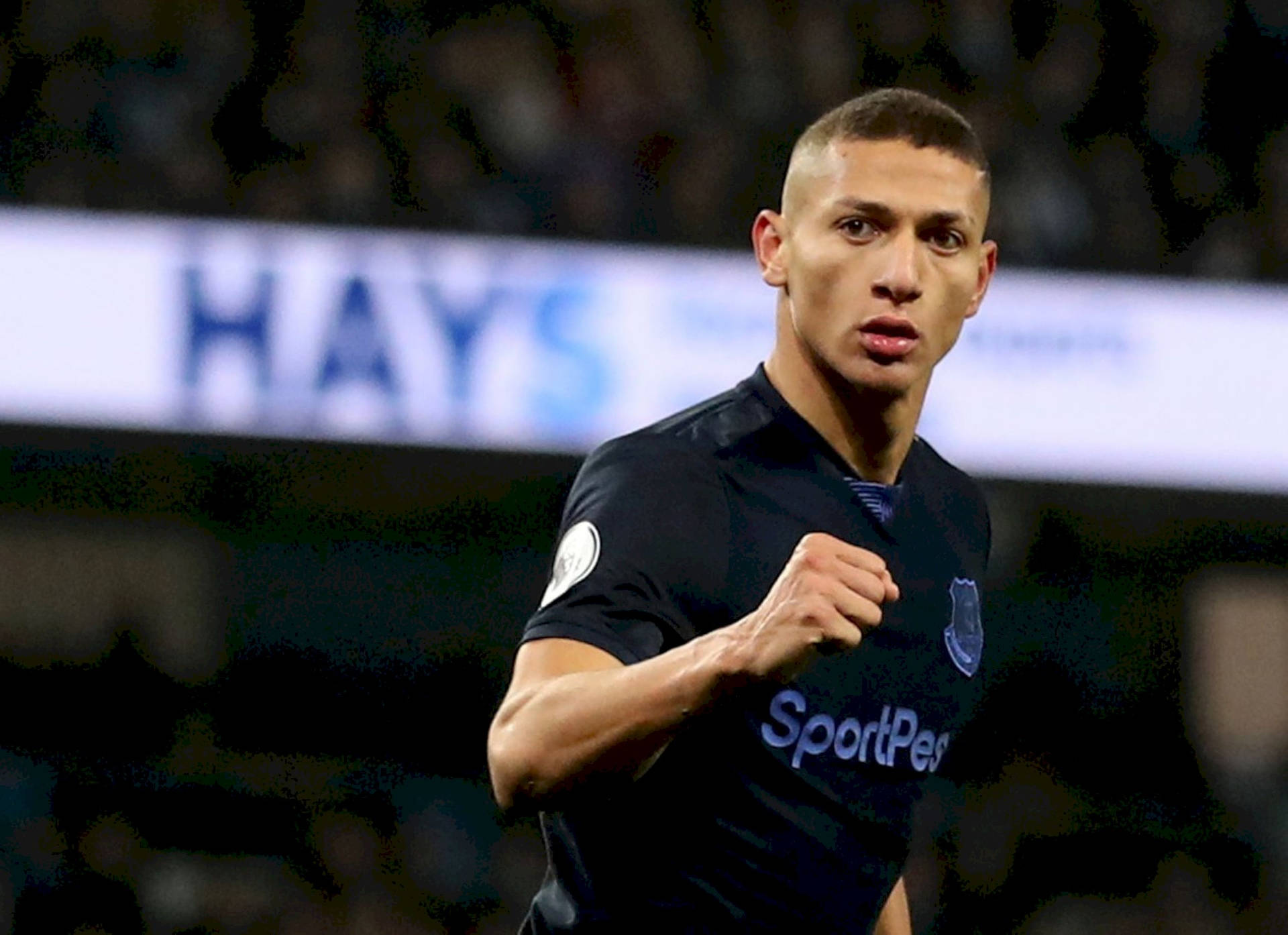 Caption: Richarlison De Andrade Triumphantly Clenching His Fist After A Successful Game Background