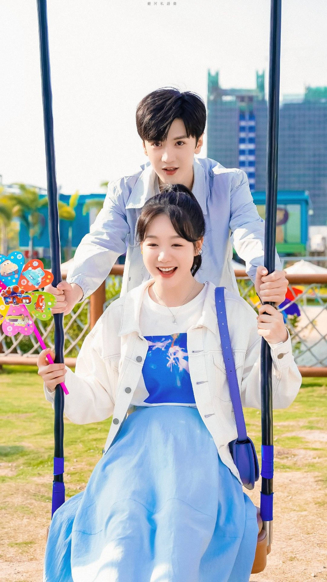 Caption: Romantic Korean Couple Enjoying A Swing Ride Background