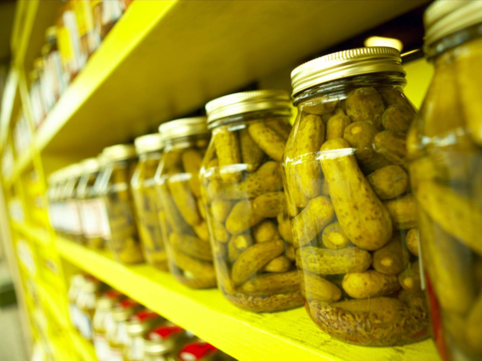 Caption: Rows Of Pickle Jars Background