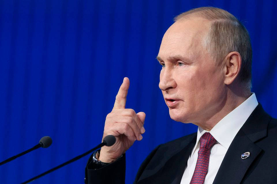 Caption: Russian President, Vladimir Putin, Making A Number 1 Hand Sign. Background