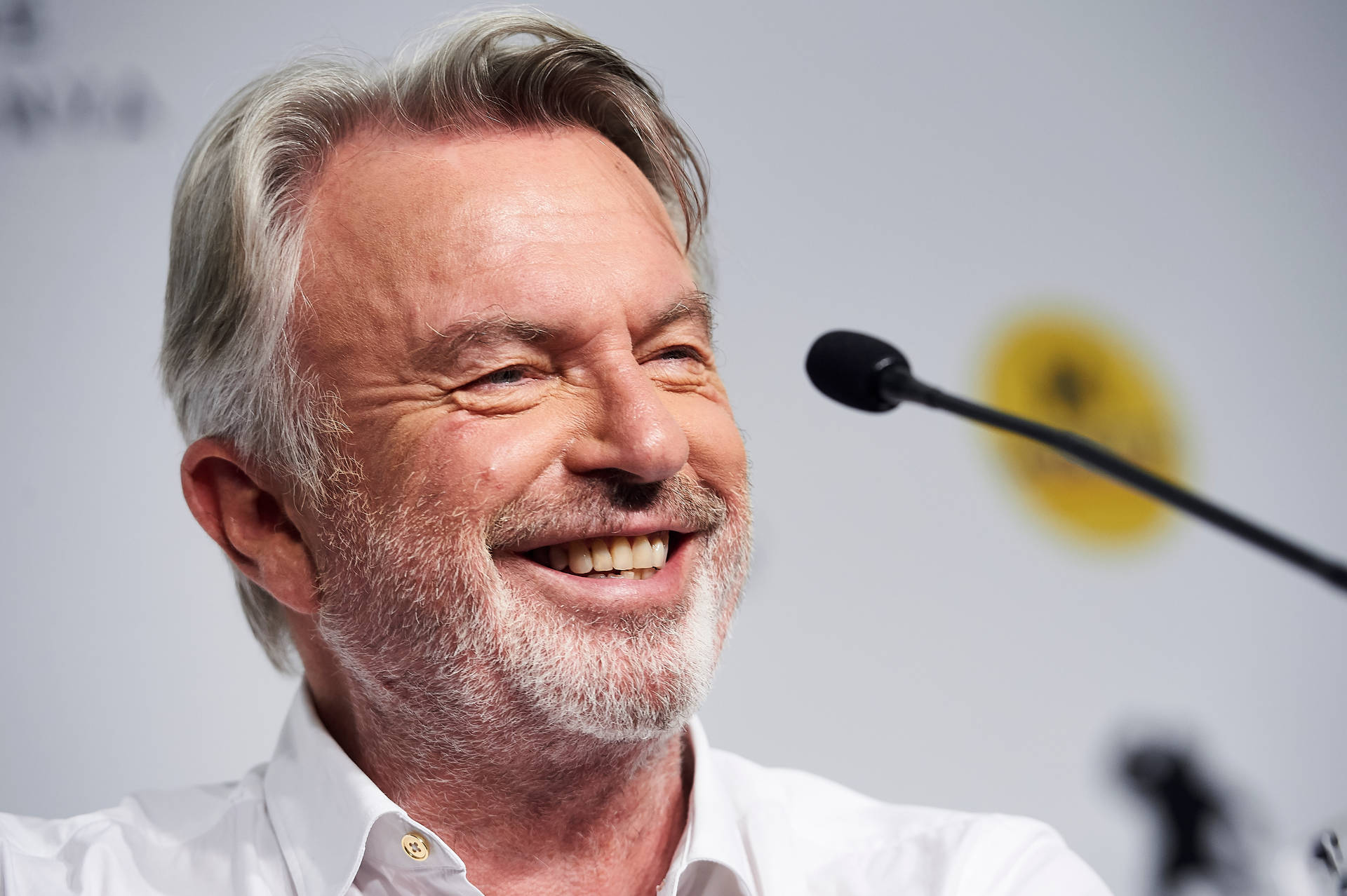 Caption: Sam Neill At 2019 Press Conference Background