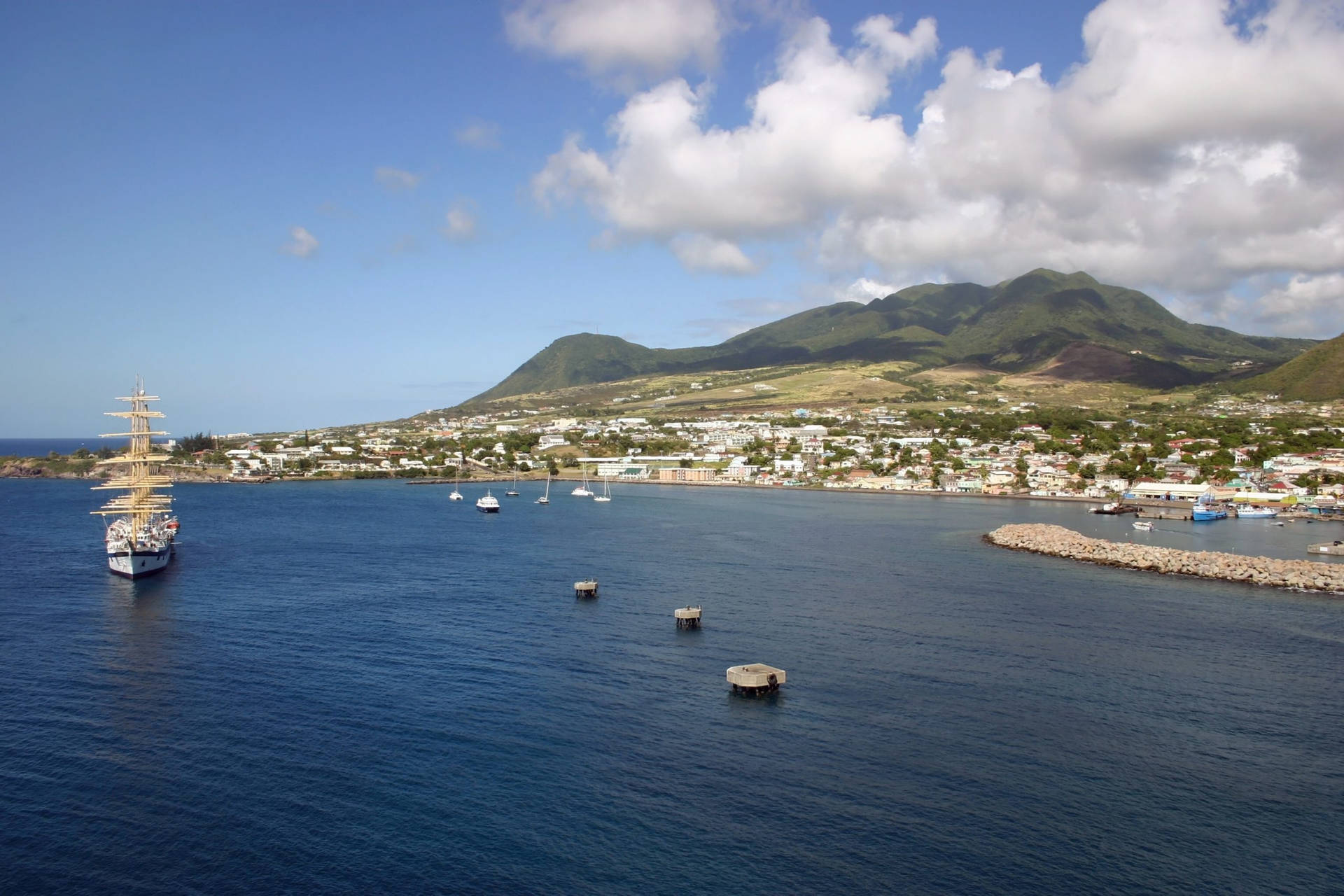 Caption: Scenic Docks And Boats In St. Kitts And Nevis Background