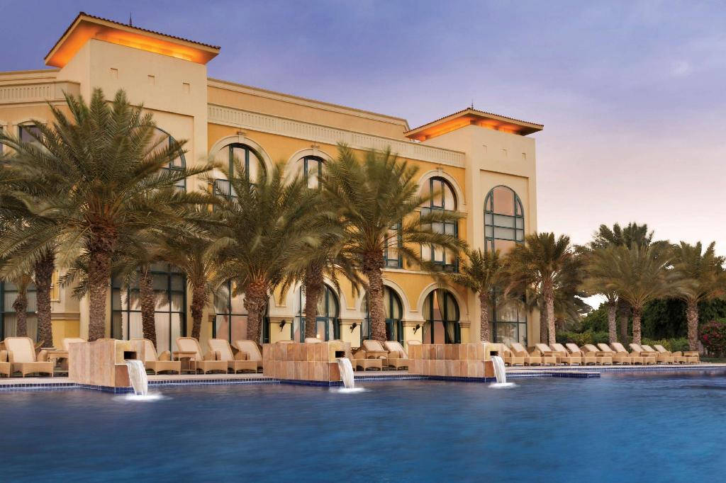 Caption: Scenic View Of The Luxurious Kempinski Palace In Djibouti Surrounded By Elegant Palm Trees. Background