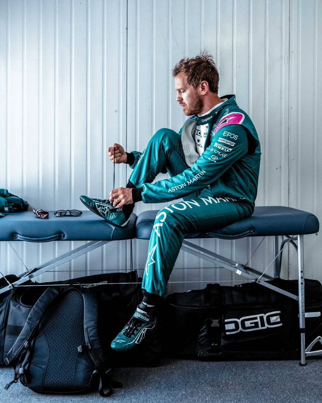 Caption: Sebastian Vettel Relaxing On A Bench Background