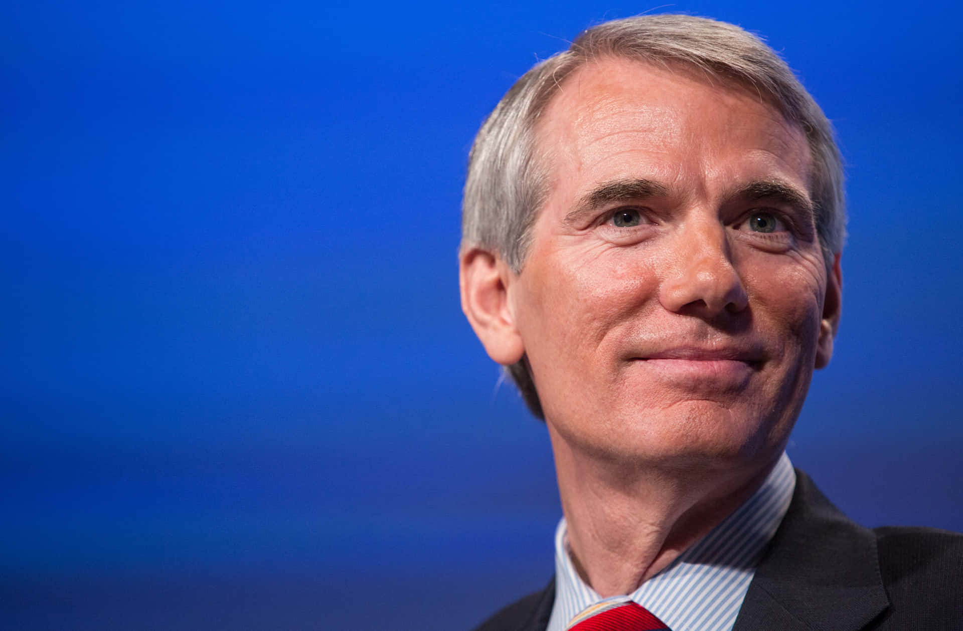 Caption: Senator Rob Portman Smiling Close-up Background