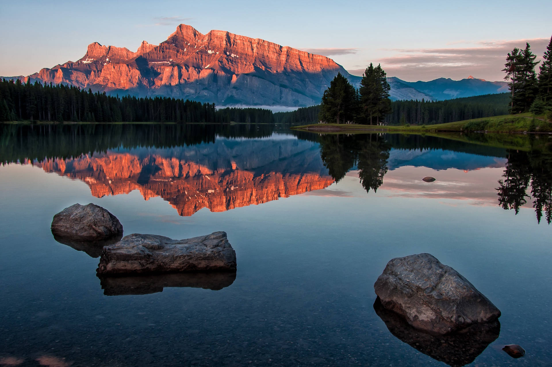 Caption: Serene Forest Lake In Alberta Background