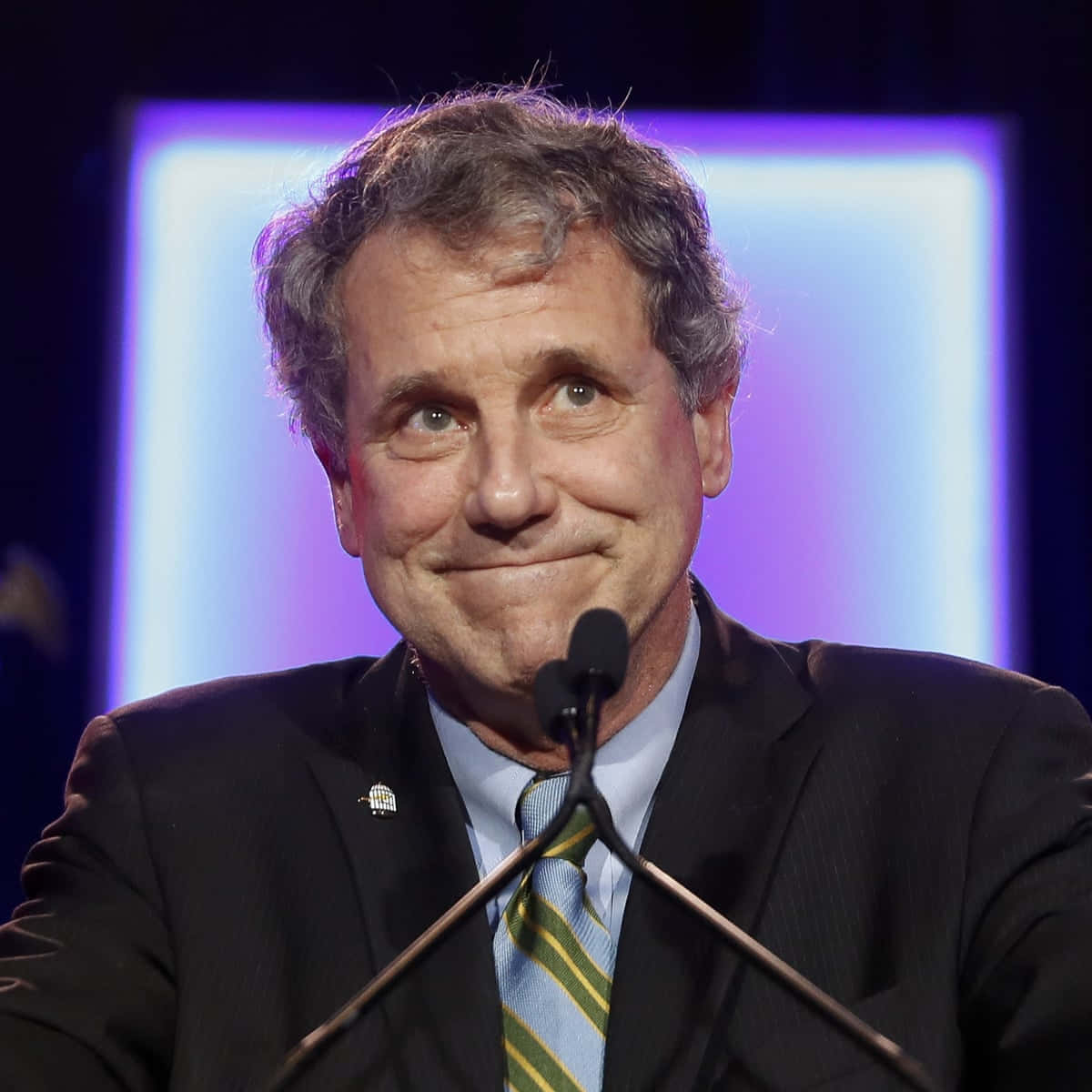 Caption: Sherrod Brown With A Grinning Expression Background