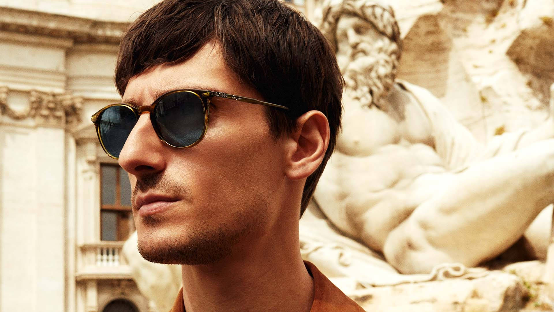 Caption: Show Off A Timeless Look With Salvatore Ferragamo Oval Sunglasses. Background