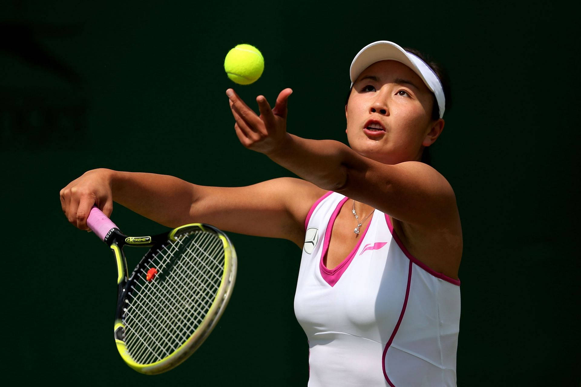 Caption: Shuai Peng In Action During Tennis Match. Background